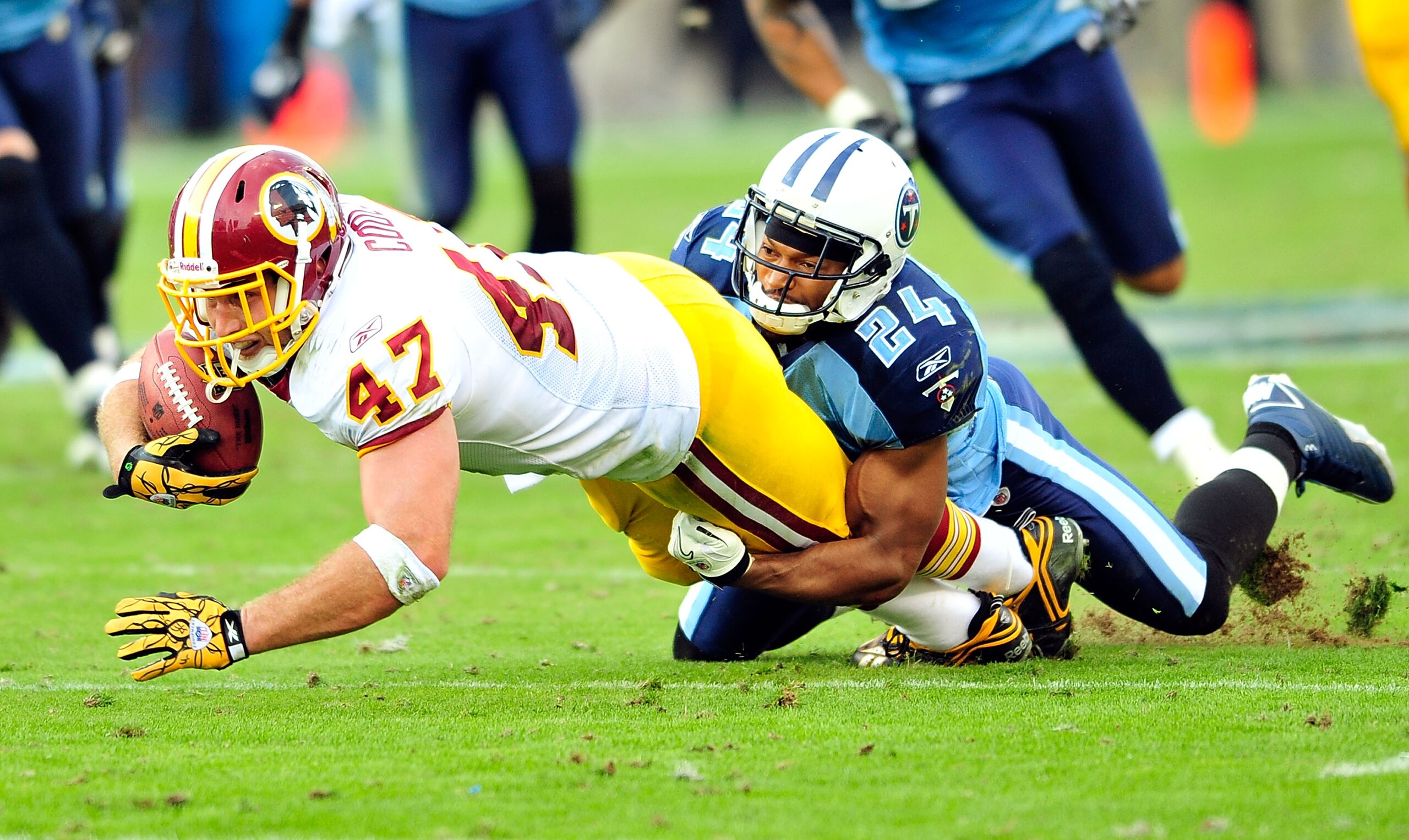 NASHVILLE, TN - NOVEMBER 21:  Chris Hope #24 of the Tennessee Titans tackles Chris Cooley #47 of the Washington Redskins at LP Field on November 21, 2010 in Nashville, Tennessee. The Redskins won 19-16 in overtime.  (Photo by Grant Halverson/Getty Images)