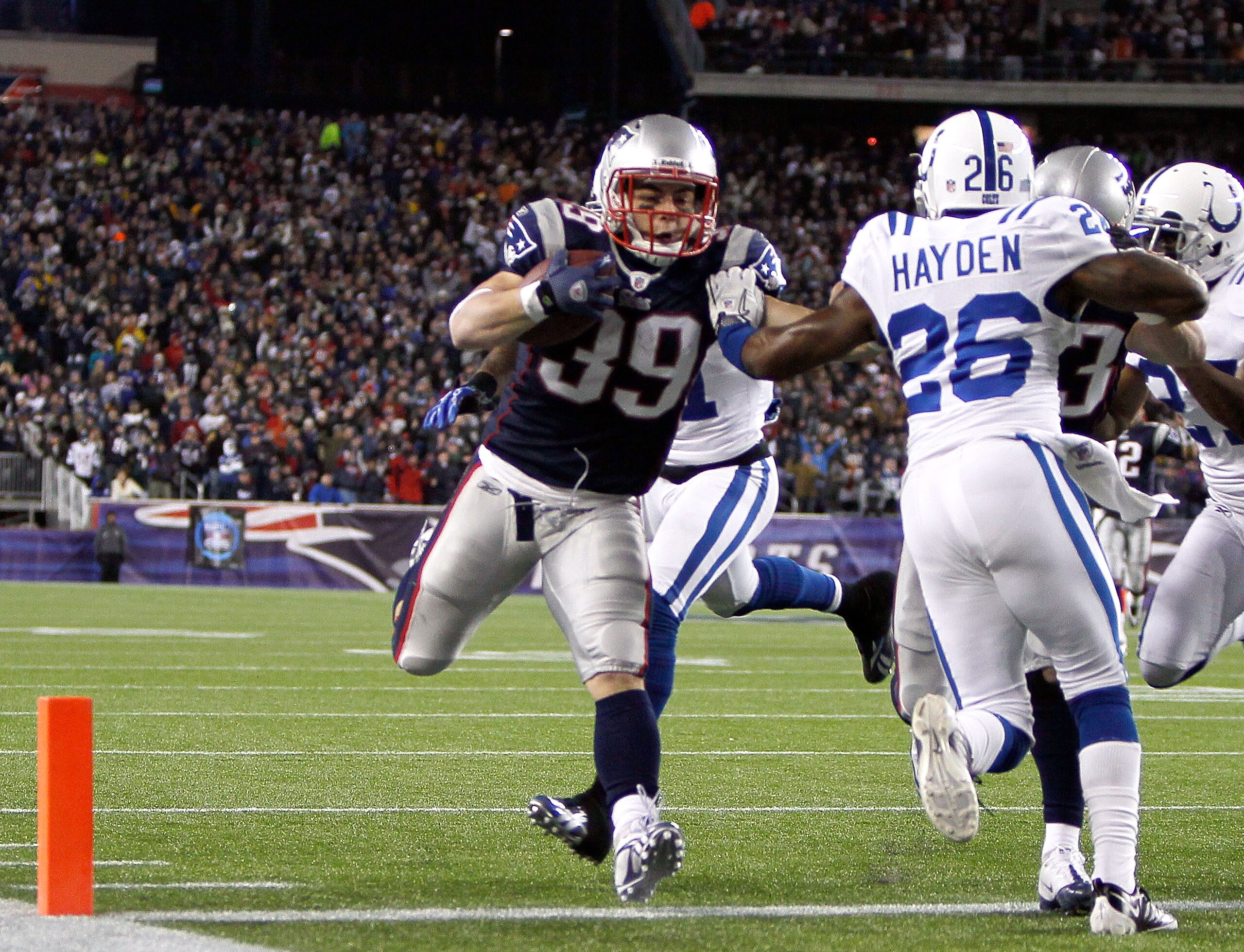 FOXBORO, MA - NOVEMBER 21:  Danny Woodhead #39 of the New England Patriots scores a touchdown in the second half despite the defense of Kelvin Hayden #26 of the Indianapolis Colts at Gillette Stadium on November 21, 2010 in Foxboro, Massachusetts. The Pat
