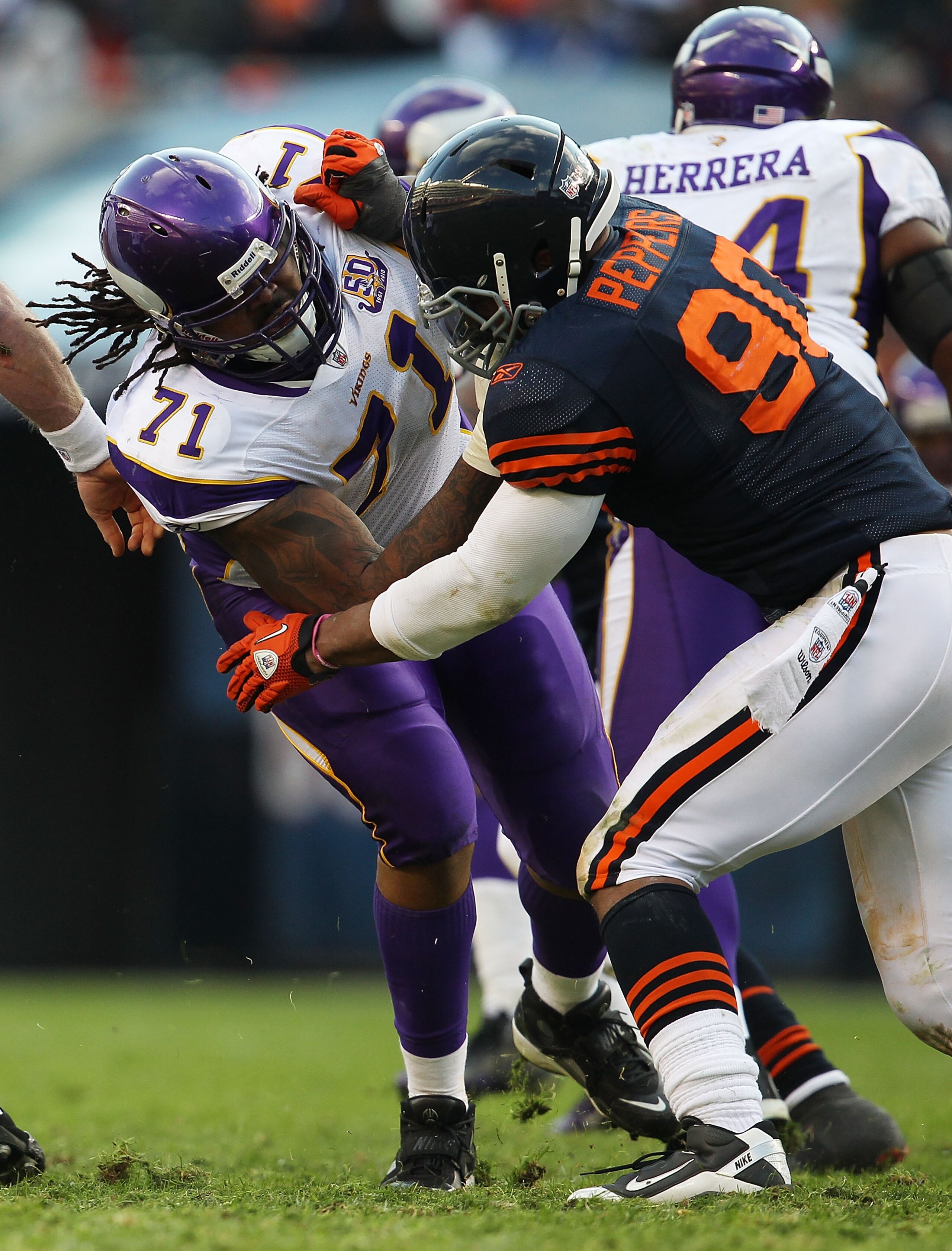 CHICAGO - NOVEMBER 14: Phil Loadholt #71 of the Minnesota Vikings tries to block Julius Peppers #90 of the Chicago Bears at Soldier Field on November 14, 2010 in Chicago, Illinois. The Bears defeated the Vikings 27-13. (Photo by Jonathan Daniel/Getty Imag