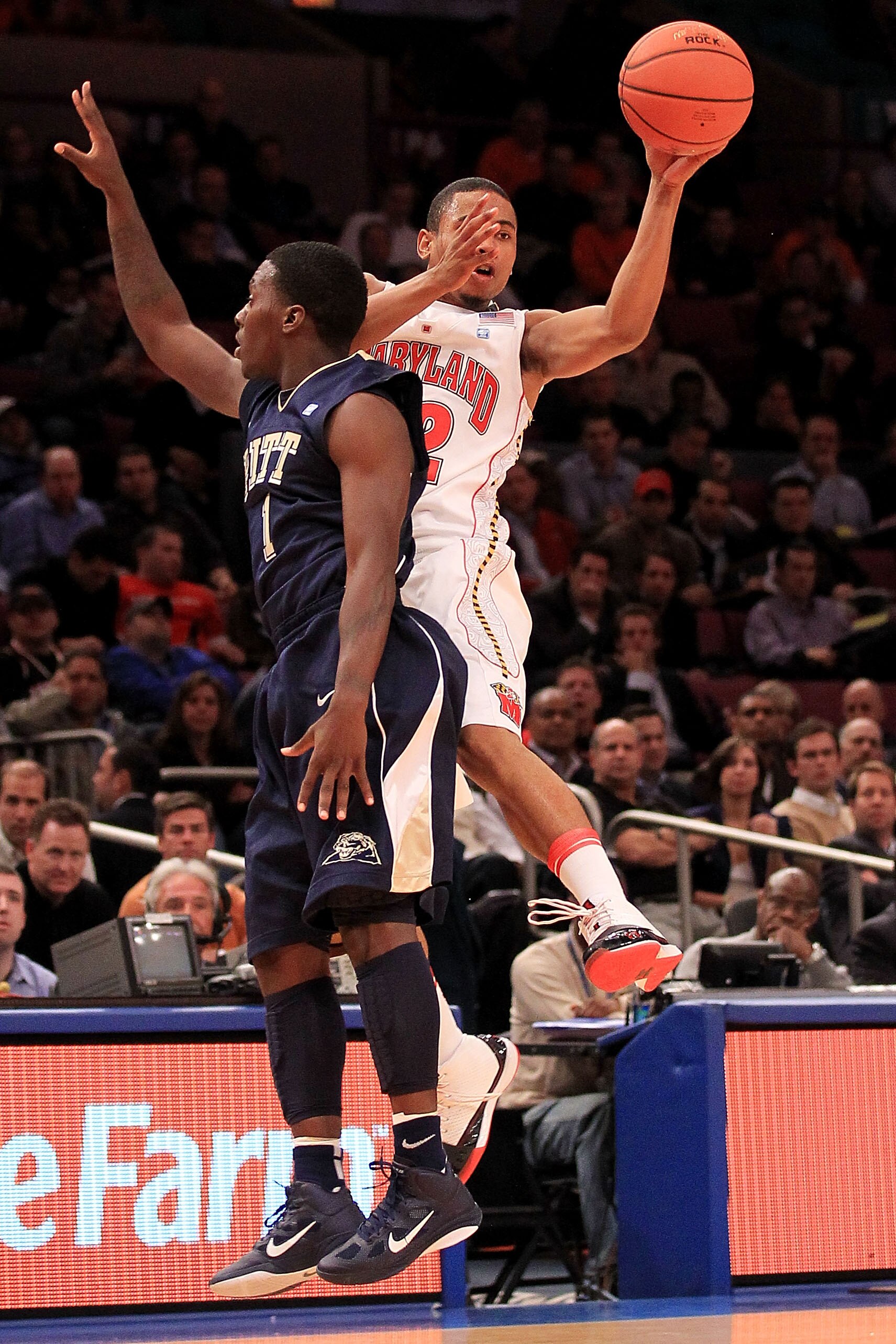 NEW YORK - NOVEMBER 18: Terrell Stoglin #12 of the Maryland Terrapin gets a pass away under pressure from Travon Woodall #1 of the Pittsburgh Panthers during the 2k Sports Classic at Madison Square Garden on November 18, 2010 in New York, New York.  (Phot