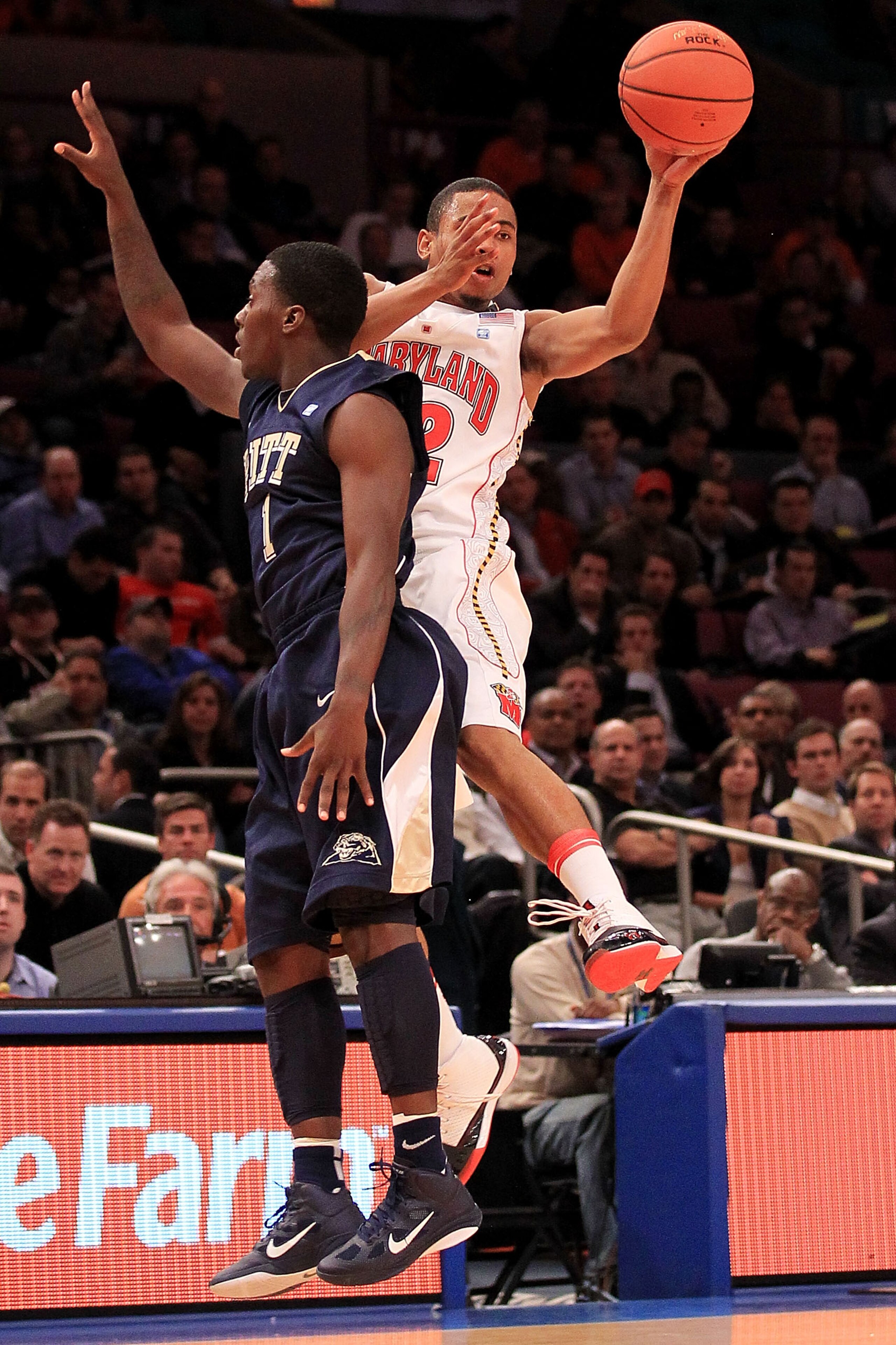 NEW YORK - NOVEMBER 18: Terrell Stoglin #12 of the Maryland Terrapin gets a pass away under pressure from Travon Woodall #1 of the Pittsburgh Panthers during the 2k Sports Classic at Madison Square Garden on November 18, 2010 in New York, New York.  (Phot