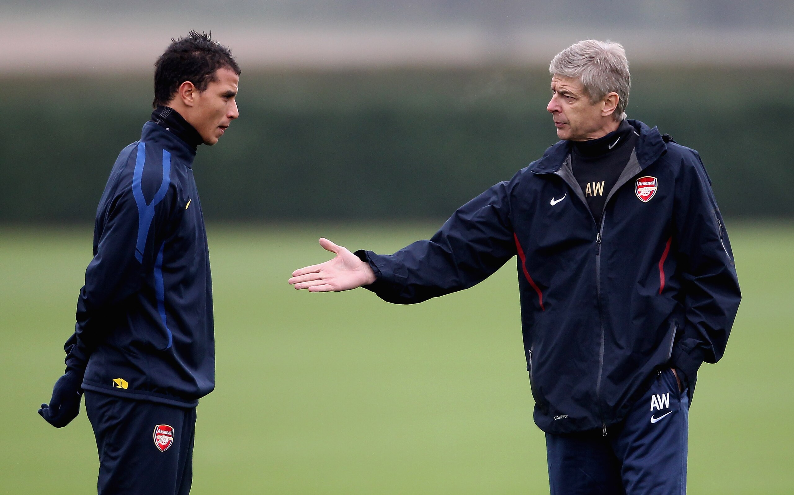 ST ALBANS, ENGLAND - NOVEMBER 22:  Arsenal manager Arsene Wenger talks to Marouane Chamakh during Arsenal training ahead of their UEFA Champions League match against Braga at London Colney on November 22, 2010 in St Albans, England.  (Photo by Scott Heave