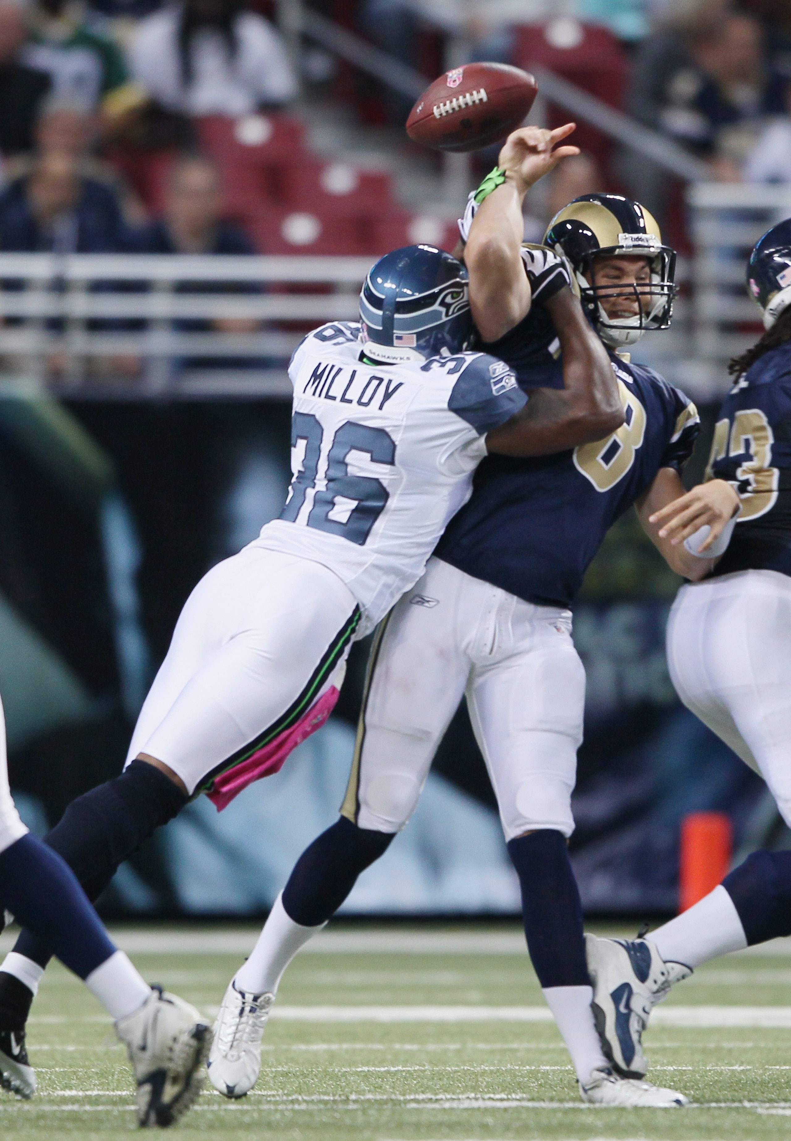 ST. LOUIS - OCTOBER 03: Sam Bradford #8 of the St. Louis Rams is hit by Lawyer Milloy #36 of the Seattle Seahawks during the first half on October 3, 2010 at Edward Jones Dome in St. Louis, Missouri.  (Photo by Elsa/Getty Images)