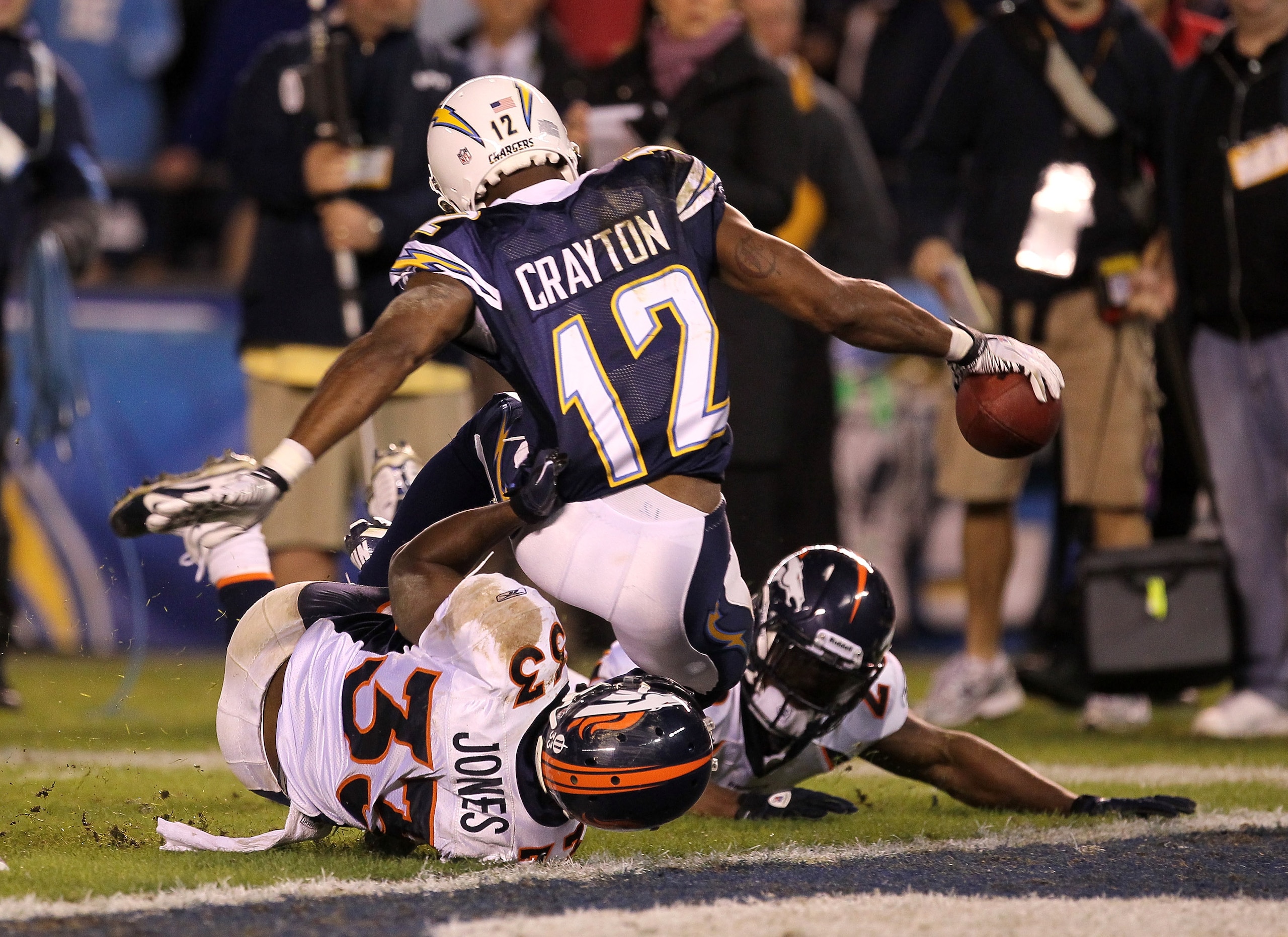 SAN DIEGO - NOVEMBER 22:  Wide receiver Patrick Crayton #12 of the San Diego Chargers reaches the ball over the goal line as he is tackled by cornerback Nate Jones #33 of the Denver Broncos to finish a 40 yard pass play and run for a touchdown at Qualcomm