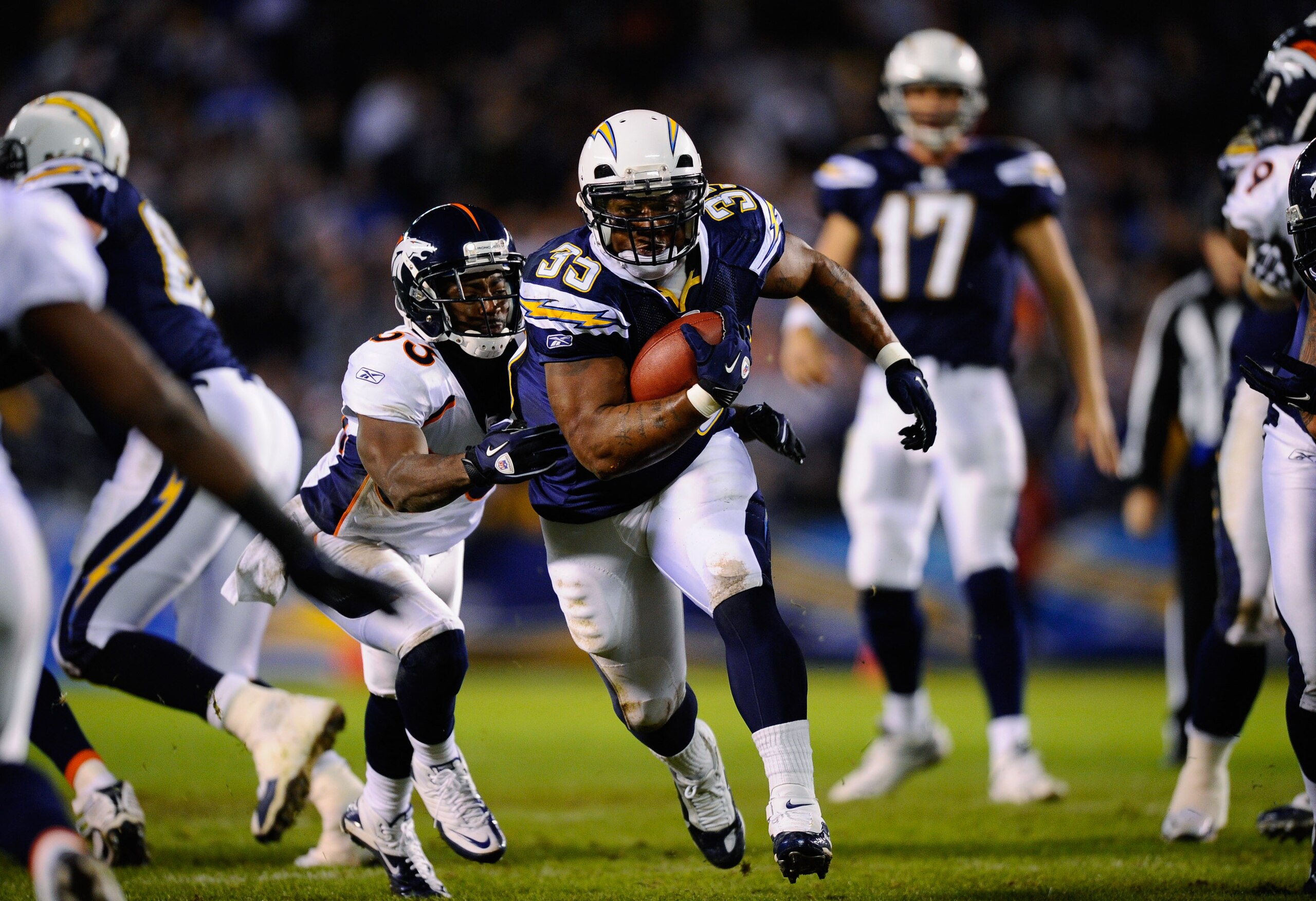 SAN DIEGO - NOVEMBER 22:  Mike Tolbert #35 of the San Diego Chargers breaks a tackle against Nate Jones #33 of the Denver Broncos as he rushes for a gain at Qualcomm Stadium on November 22, 2010 in San Diego, California.  (Photo by Kevork Djansezian/Getty
