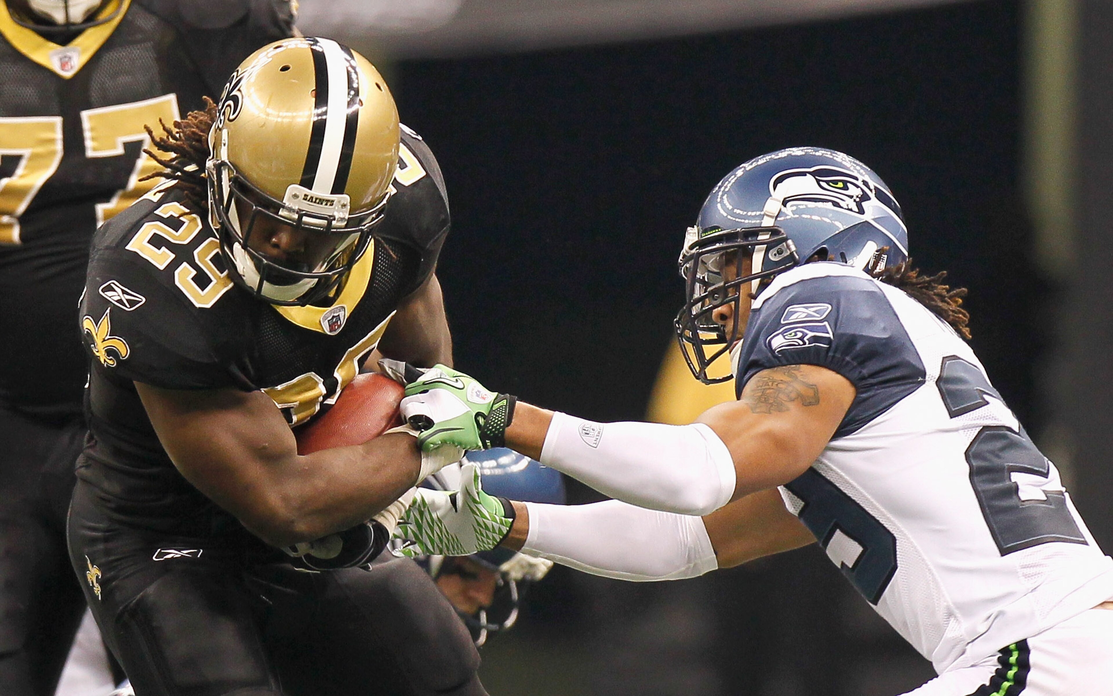 NEW ORLEANS - NOVEMBER 21:  Earl Thomas #29 of the Seattle Seahawks tries to strip the ball from Chris Ivory #29 of the New Orleans Saints at Louisiana Superdome on November 21, 2010 in New Orleans, Louisiana.  (Photo by Kevin C. Cox/Getty Images)