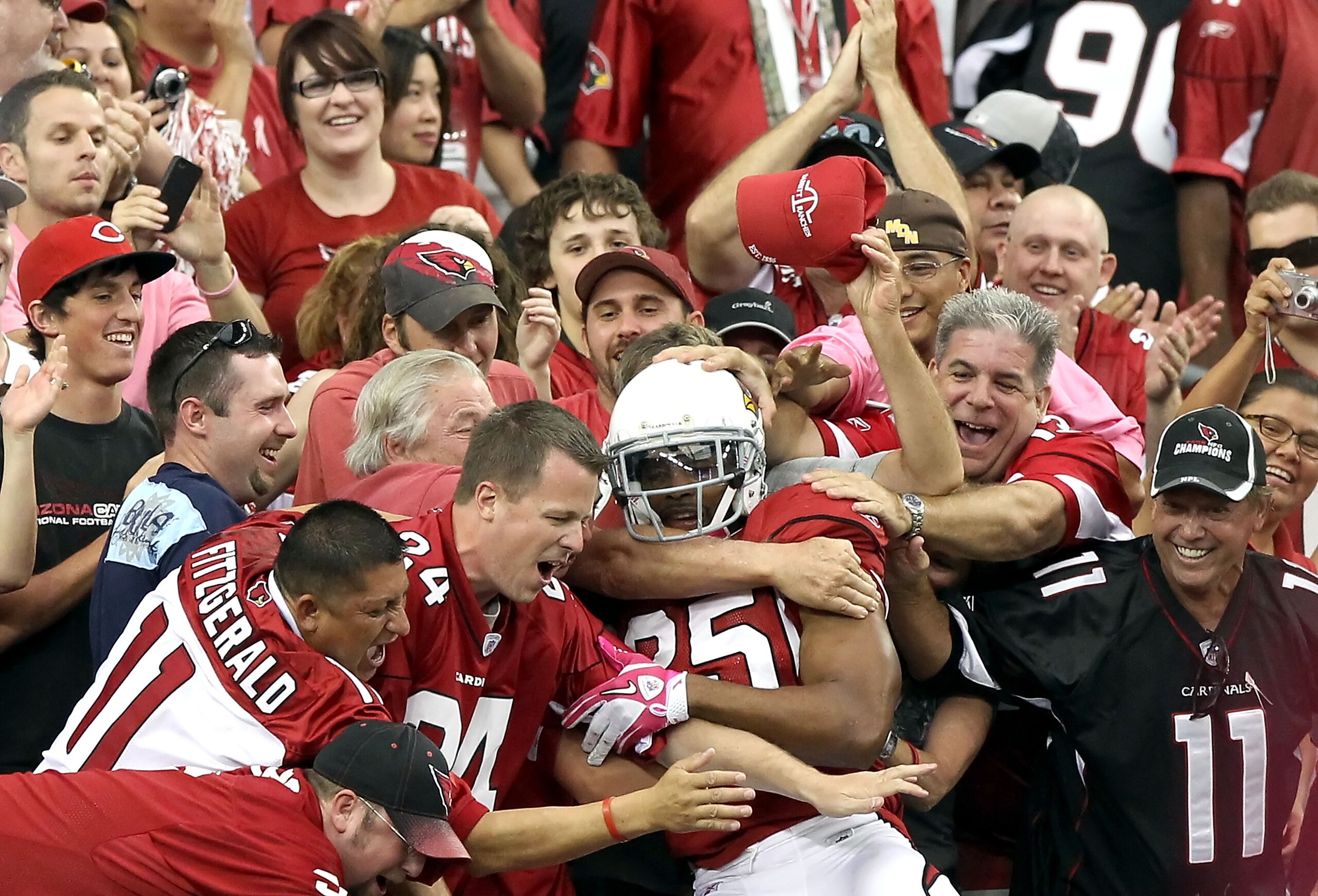 GLENDALE, AZ - OCTOBER 10: Safety Kerry Rhodes #25 of the Arizona Cardinals celebrates with fans after scoring a touchdown on a fumble recovery during the fourth quarter of the NFL game against the New Orleans Saints at the University of Phoenix Stadium GLENDALE, AZ - OCTOBER 10: Safety Kerry Rhodes #25 of the Arizona Cardinals celebrates with fans after scoring a touchdown on a fumble recovery during the fourth quarter of the NFL game against the New Orleans Saints at the University of Phoenix Stadium