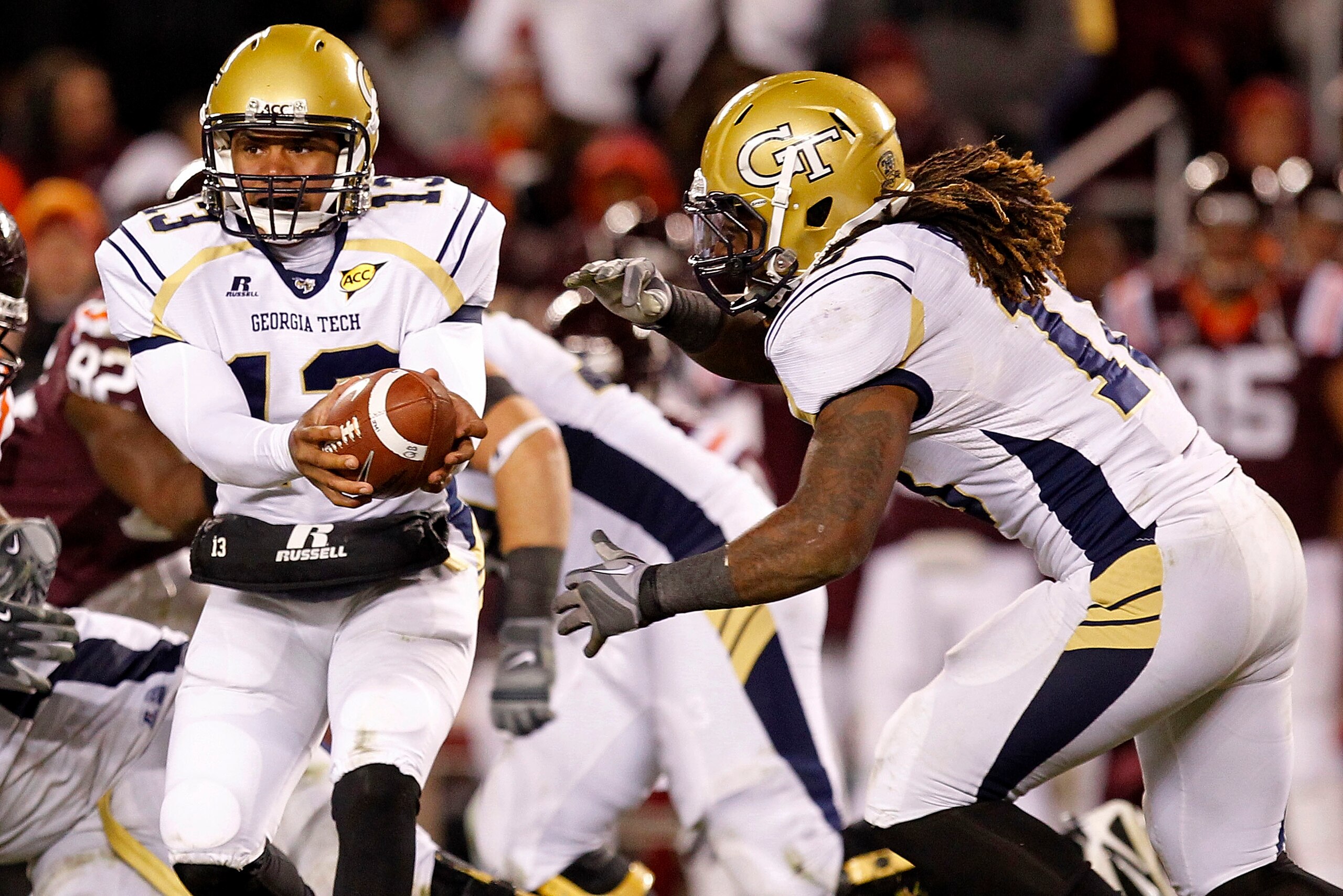 BLACKSBURG, VA - NOVEMBER 04: Quarterback Tevin Washington #13 of the Georgia Tech Yellow Jackets hands the ball off to running back Anthony Allen #18 of the Georgia Tech Yellow Jackets against the Virginia Tech Hokies at Lane Stadium on November 4, 2010