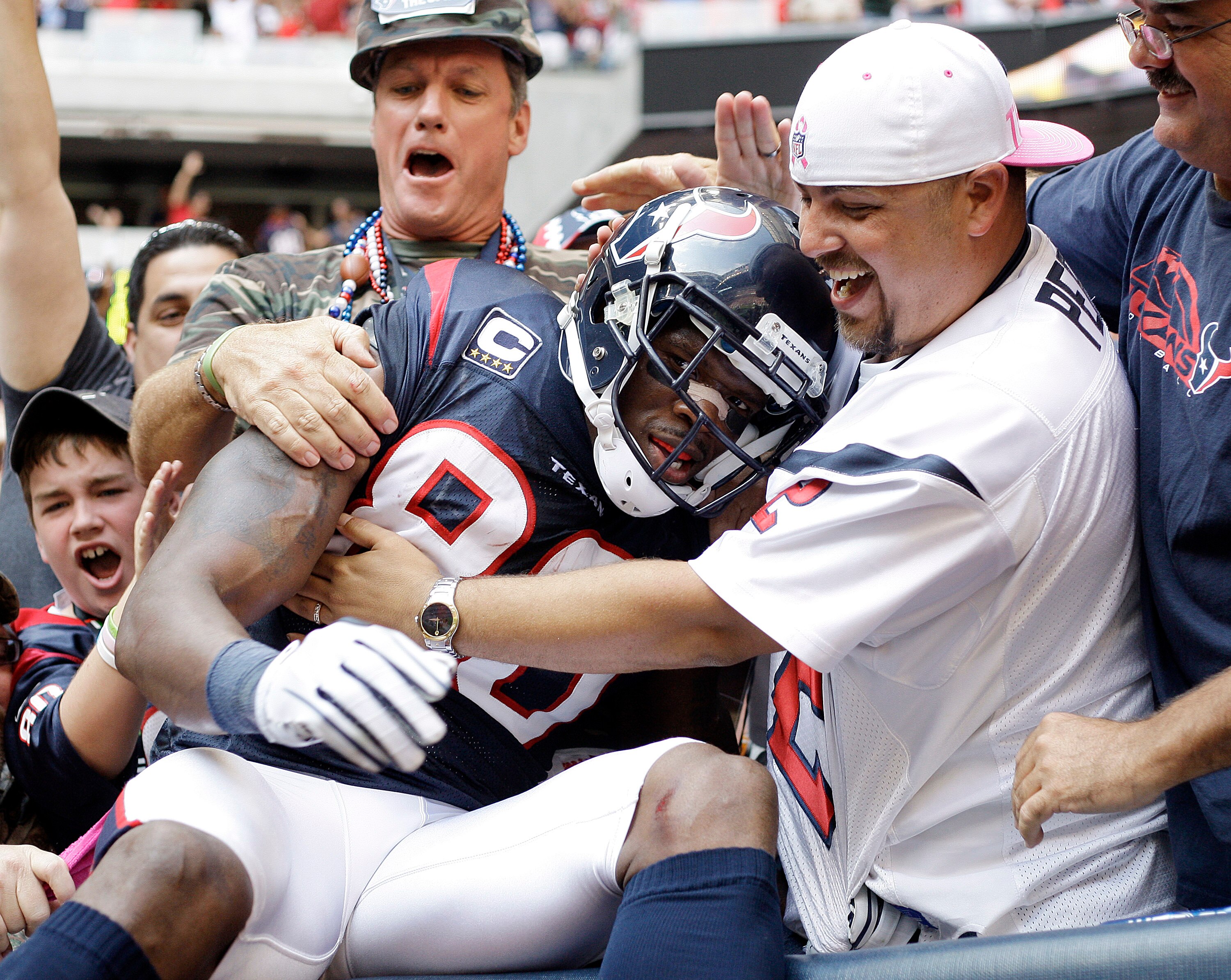 HOUSTON - OCTOBER 17:  Andre Johnson #80 of the Houston Texans is mobbed by fans after he scored the go ahead touchdown in the fourth quarter against the Kansas City Chiefs at Reliant Stadium on October 17, 2010 in Houston, Texas.  (Photo by Bob Levey/Get