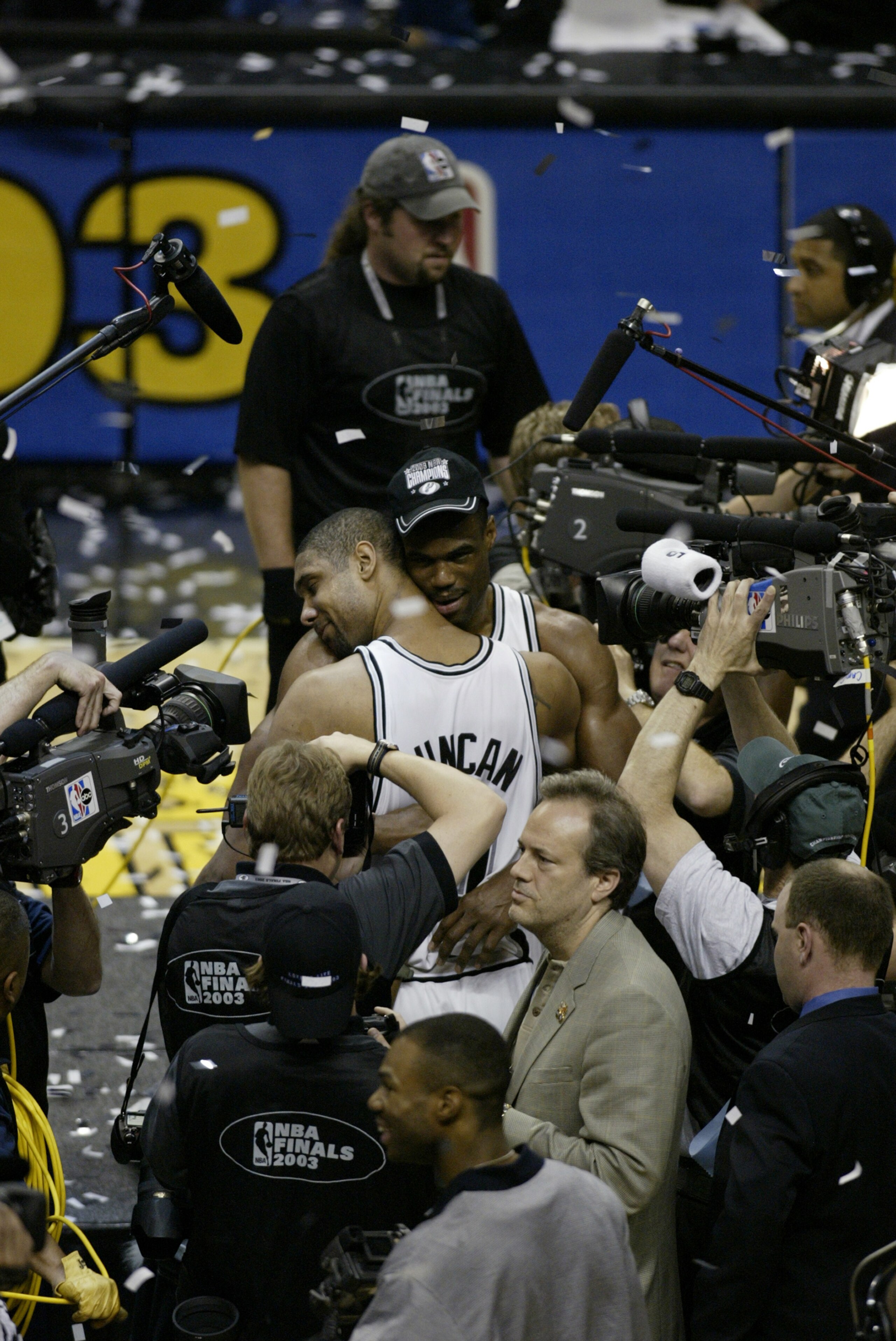 SAN ANTONIO - JUNE 15:  David Robinson #50 and Tim Duncan #21 of the San Antonio Spurs celebrate the NBA Championship after defeating the New Jersey Nets in game six of the 2003 NBA Finals at the SBC Center on June 15, 2003 in San Antonio, Texas.  The Spu