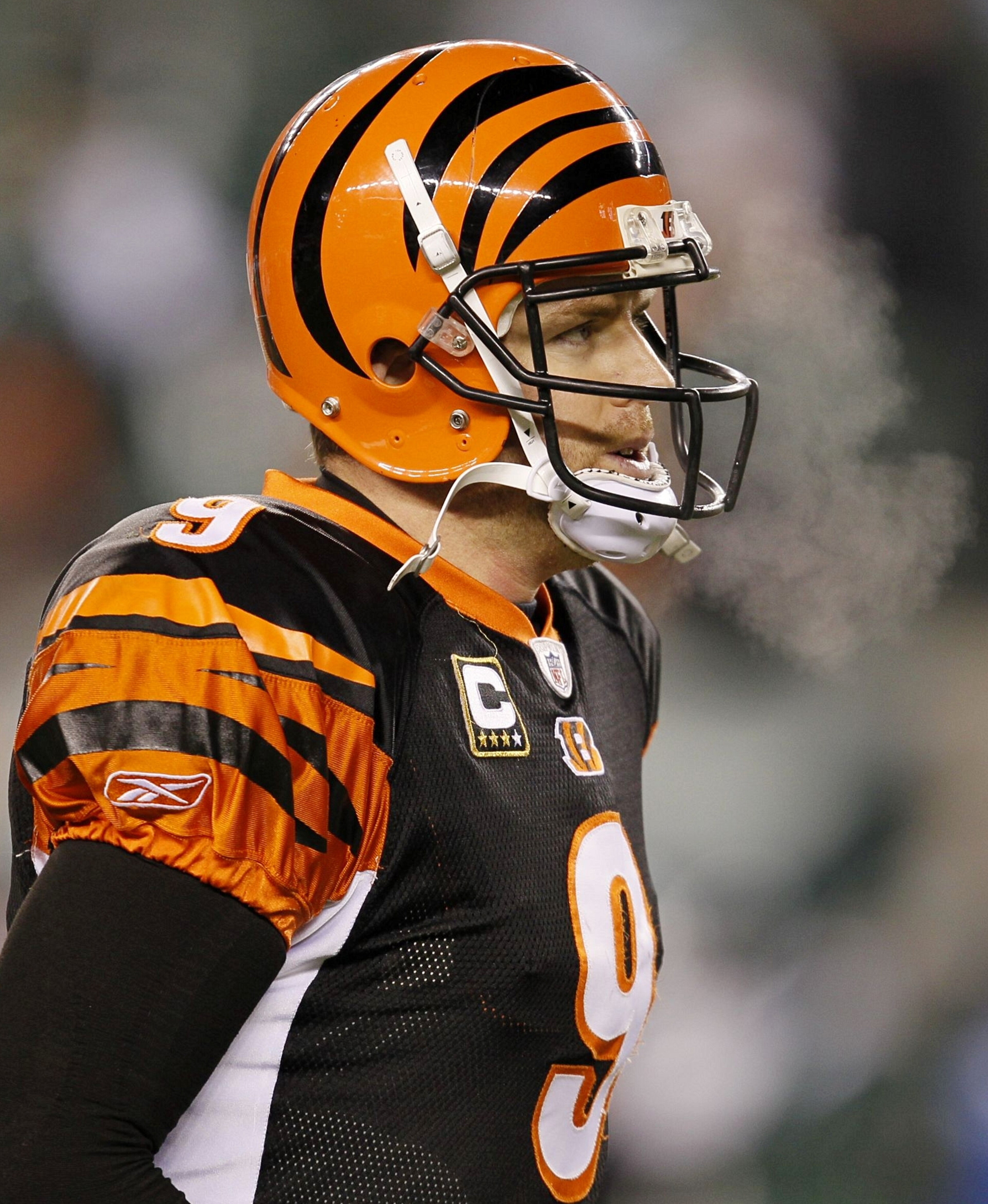 CINCINNATI - JANUARY 9:  Quarterback Carson Palmer #9 of the Cincinnati Bengals walks off the field after being defeated by the New York Jets in the 2010 AFC wild-card playoff game at Paul Brown Stadium on January 9, 2010 in Cincinnati, Ohio. (Photo by Jo