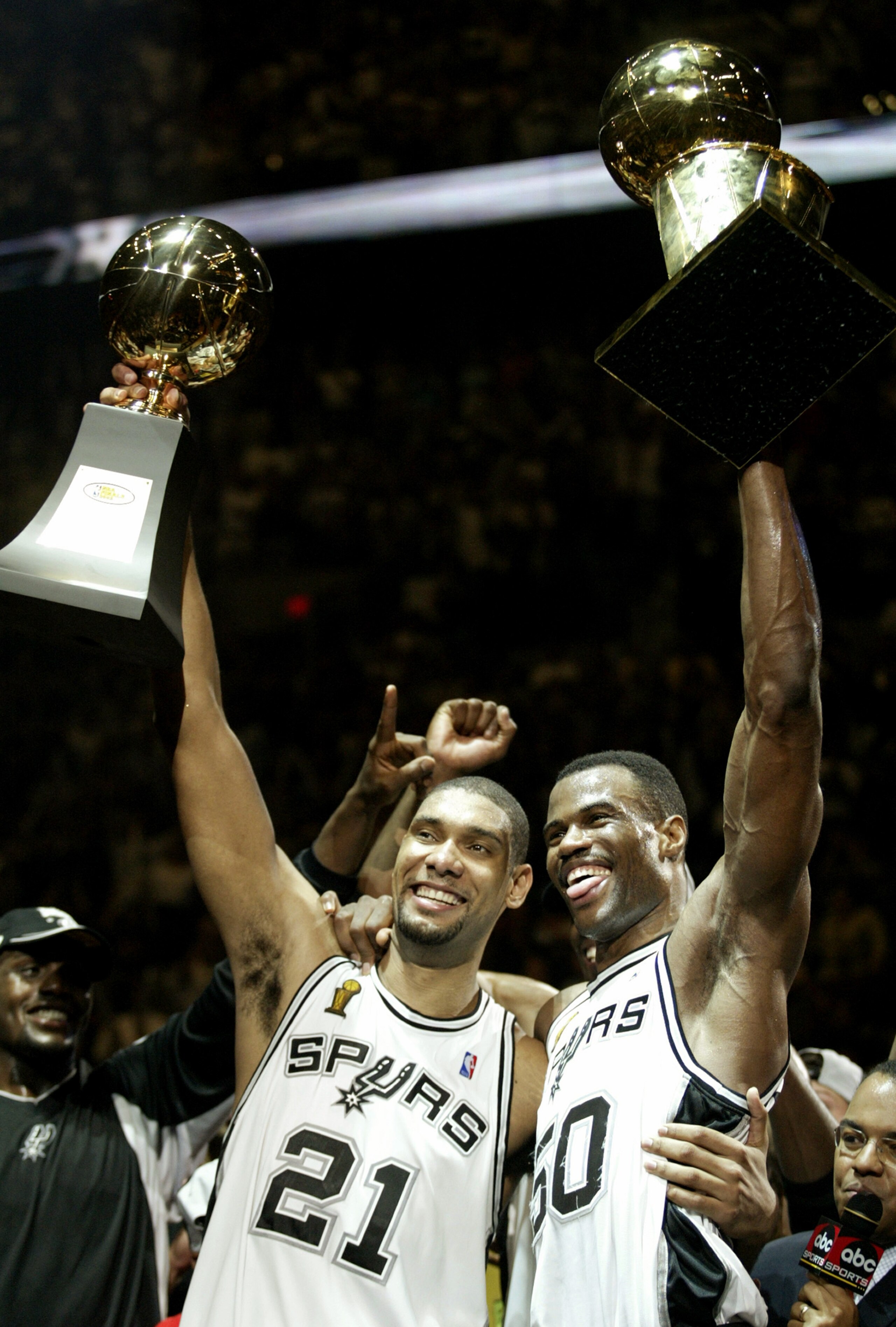 SAN ANTONIO, TX - JUNE 15:  Tim Duncan #21 and David Robinson #50 of the San Antonio Spurs celebrate after winning Game six of the 2003 NBA Finals against the New Jersey Nets on June 15, 2003 at the SBC Center in San Antonio, Texas.  The Spurs won 88-77 a