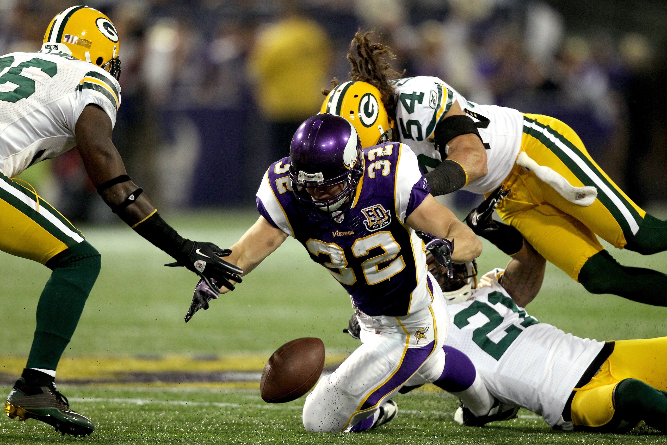 MINNEAPOLIS - NOVEMBER 21:  Toby Gerhart #32 of the Minnesota Vikings has the ball jarred loose by Charles Woodson #21 and Brandon Chillar #54 of the Green Bay Packers at the Hubert H. Humphrey Metrodome on November 21, 2010 in Minneapolis, Minnesota.  (P