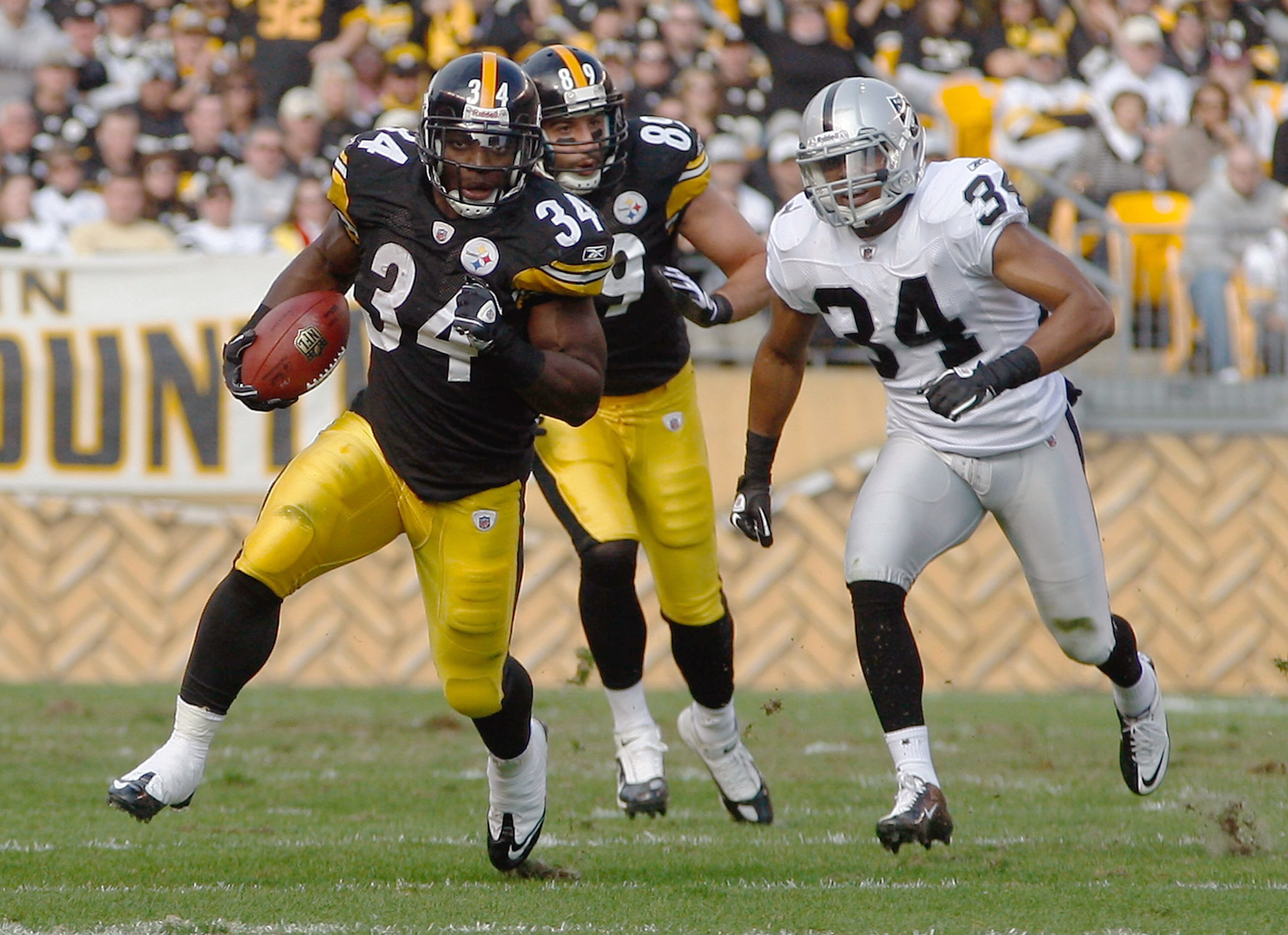 PITTSBURGH - NOVEMBER 21:  Rashard Mendenhall #34 of the Pittsburgh Steelers runs by Mike Mitchell #34 of the Oakland Raiders during the game on November 21, 2010 at Heinz Field in Pittsburgh, Pennsylvania.  (Photo by Jared Wickerham/Getty Images)