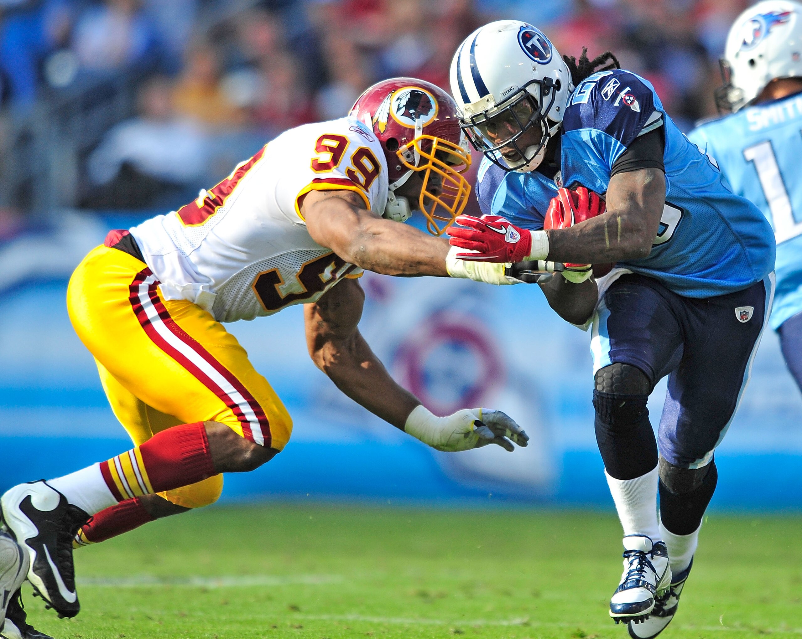 NASHVILLE, TN - NOVEMBER 21:  Andre Carter #99 of the Washington Redskins tackles Chris Johnson #28 of the Tennessee Titans at LP Field on November 21, 2010 in Nashville, Tennessee. The Redskins won 19-16 in overtime.  (Photo by Grant Halverson/Getty Imag