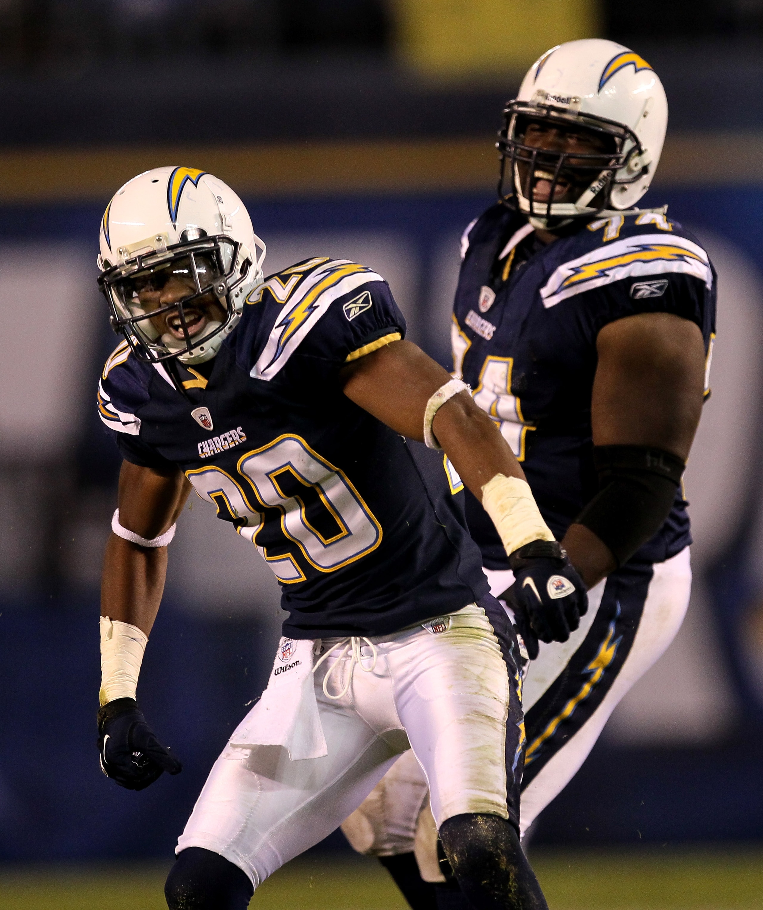 SAN DIEGO - NOVEMBER 22:  Cornerback Antoine Cason #20 and defensive end Jacques Cesaire #74 of the San Diego Chargers celebrate a stop against the Denver Broncos at Qualcomm Stadium on November 22, 2010 in San Diego, California. The Chargers won 35-14.
