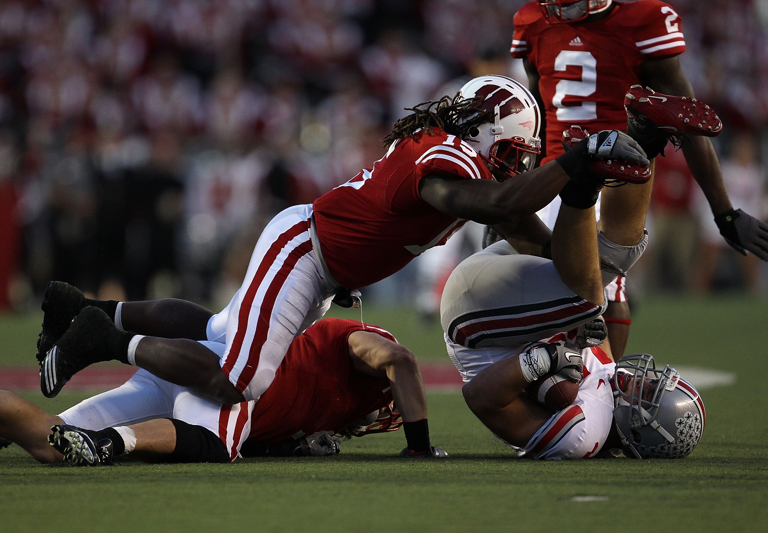 MADISON, WI - OCTOBER 16: Zach Boren #44 of the Ohio State Buckeyes is tackled by Blake Sorensen #9 and Culmer St. Jean #15 of the Wisconsin Badgers at Camp Randall Stadium on October 16, 2010 in Madison, Wisconsin. Wisconsin defeated Ohio State 31-18. (P