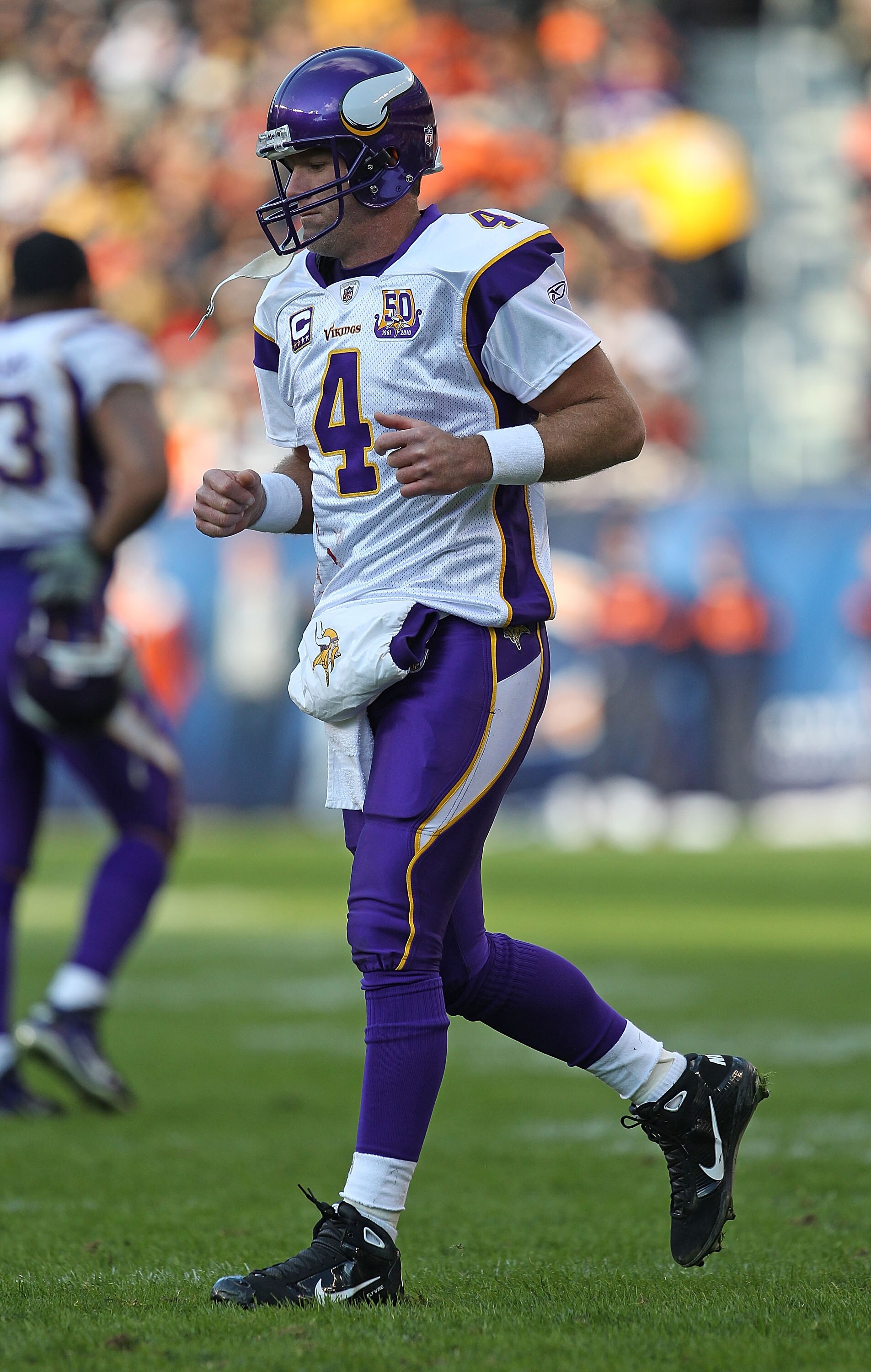 CHICAGO - NOVEMBER 14: Brett Favre #4 of the Minnesota Vikings walks back to the field of play from the sidelines during a game against the Chicago Bears at Soldier Field on November 14, 2010 in Chicago, Illinois. The Bears defeated the Vikings 27-13. (Ph