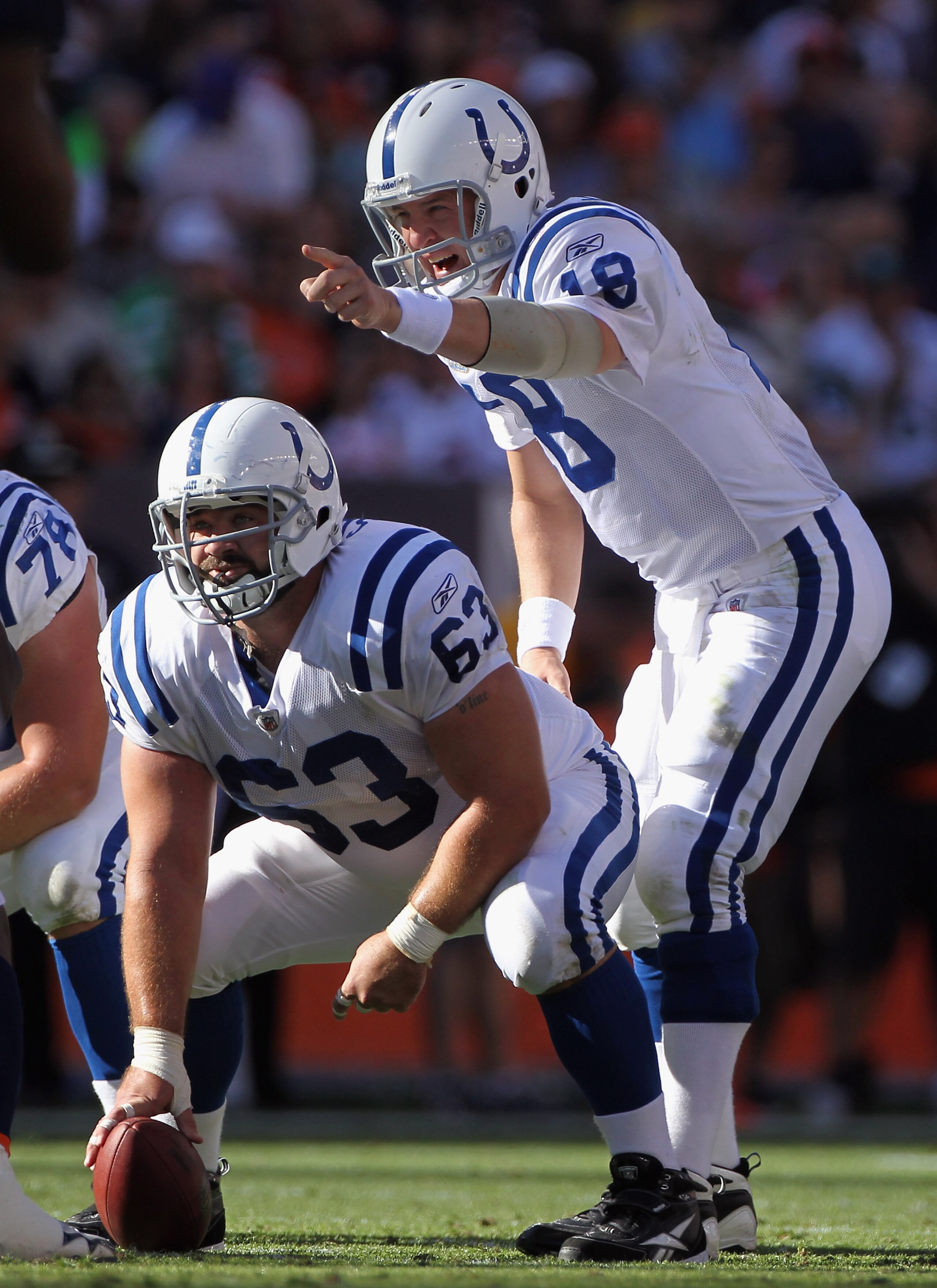 DENVER - SEPTEMBER 26:  Quarterback Peyton Manning #18 of the Indianapolis Colts directs the offense as center Jeff Saturday #63 prepares to snap the ball against the Denver Broncos at INVESCO Field at Mile High on September 26, 2010 in Denver, Colorado.