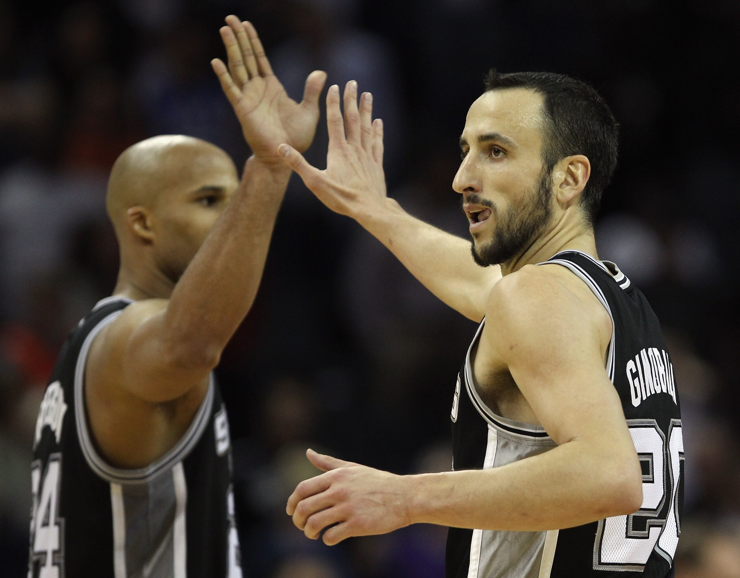 CHARLOTTE, NC - NOVEMBER 08:  Manu Ginobili #20 of the San Antonio Spurs celebrates with teammate Richard Jefferson #24 after making a basket late in the 4th quarter giving the Spurs a 95-91 victory over the Charlotte Bobcats during their game at Time War