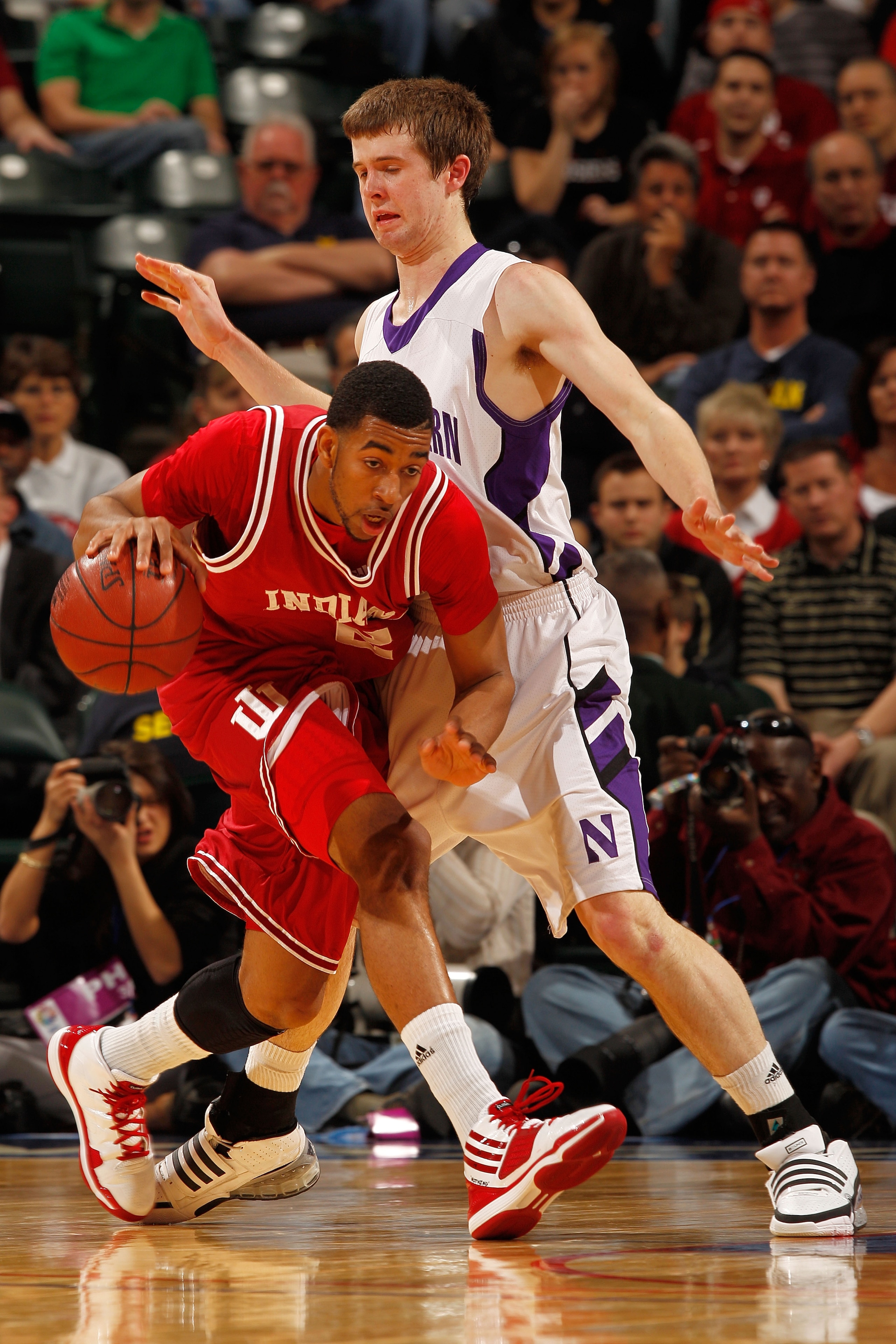 INDIANAPOLIS - MARCH 11:  Forward Christian Watford #2 of the Indiana Hoosiers drives with the ball against forward John Shurna #24 of the Northwestern Wildcats during the first round of the Big Ten Men's Basketball Tournament at Conseco Fieldhouse on Mar