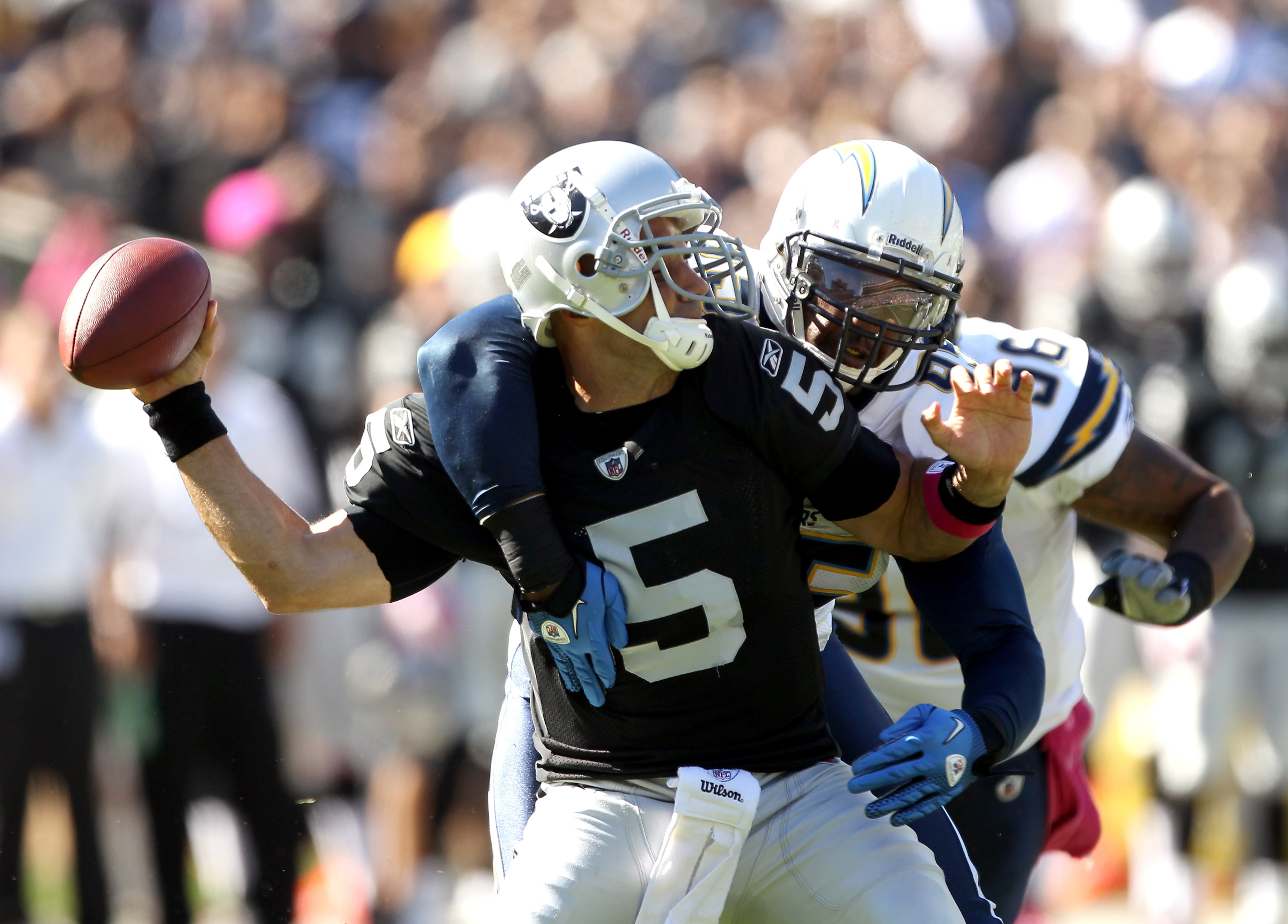 OAKLAND, CA - OCTOBER 10: Bruce Gradkowski #5 of the Oakland Raiders is hit by Shaun Phillips #95 of the San Diego Chargers at Oakland-Alameda County Coliseum on October 10, 2010 in Oakland, California. (Photo by Ezra Shaw/Getty Images) OAKLAND, CA - OCTOBER 10: Bruce Gradkowski #5 of the Oakland Raiders is hit by Shaun Phillips #95 of the San Diego Chargers at Oakland-Alameda County Coliseum on October 10, 2010 in Oakland, California. (Photo by Ezra Shaw/Getty Images)