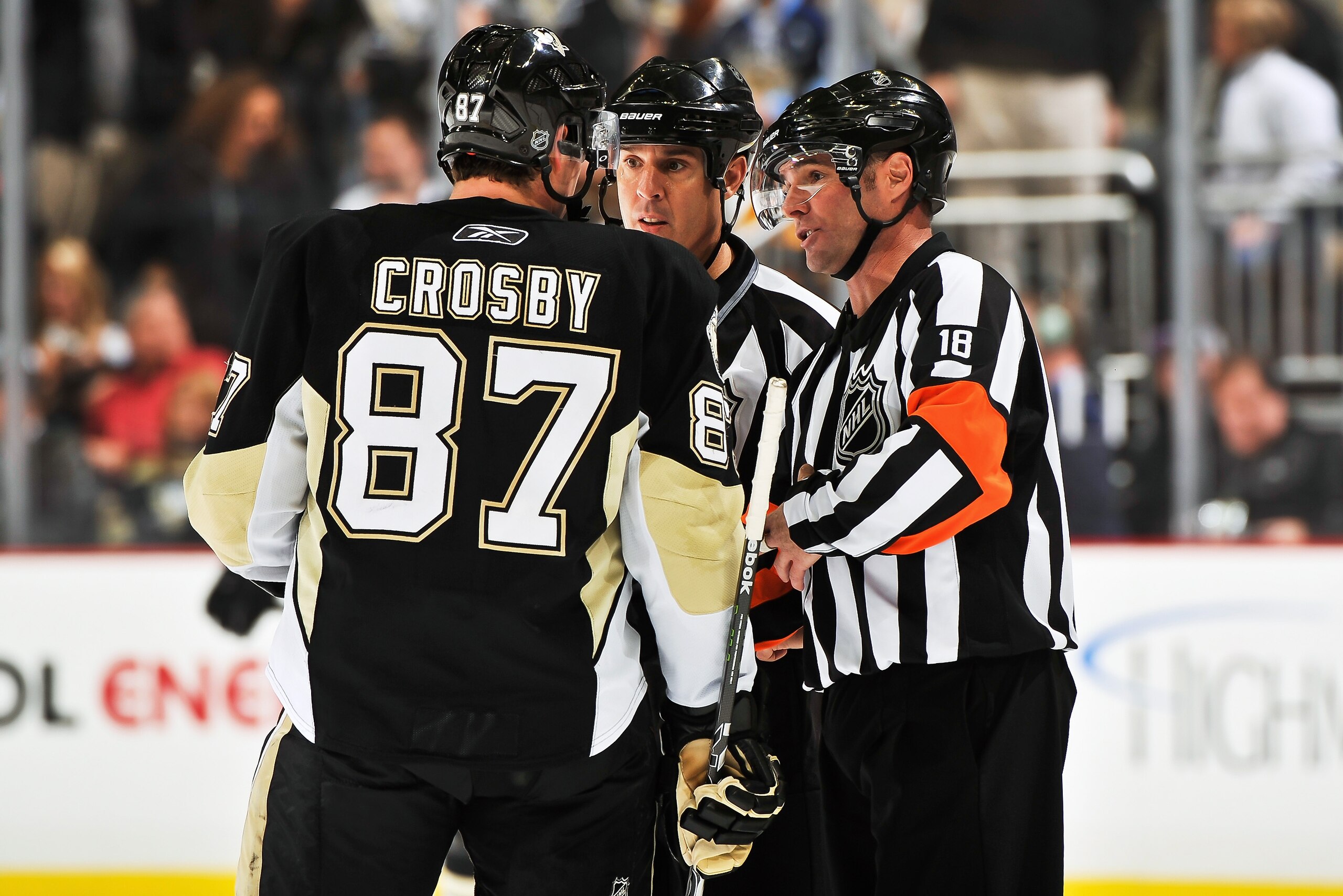 PITTSBURGH - NOVEMBER 19:  Sidney Crosby #87 of the Pittsburgh Penguins talks with officials Tony Sericolo #84 and Greg Kimmerly #18 during a game against the Carolina Hurricanes on November 19, 2010 at Consol Energy Center in Pittsburgh, Pennsylvania.  (