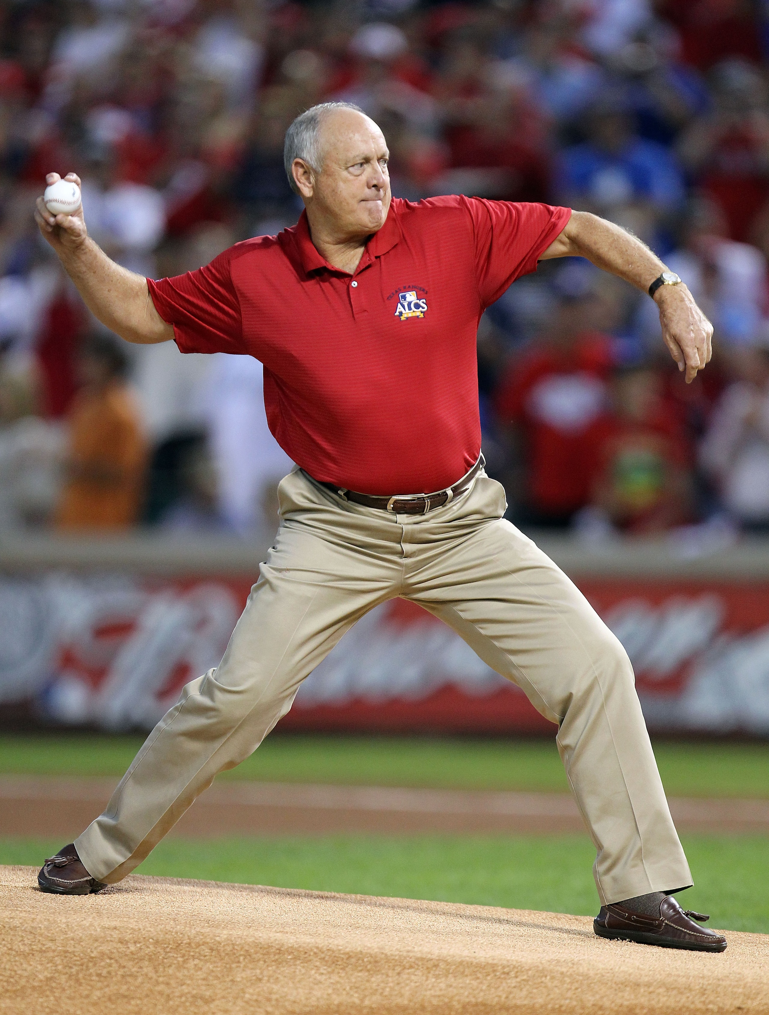 ARLINGTON, TX - OCTOBER 15:  General Manager Nolan Ryan of  the Texas Rangers throws out the ceremonial first pitch against the New York Yankees in Game One of the ALCS during the 2010 MLB Playoffs at Rangers Ballpark in Arlington on October 15, 2010 in A