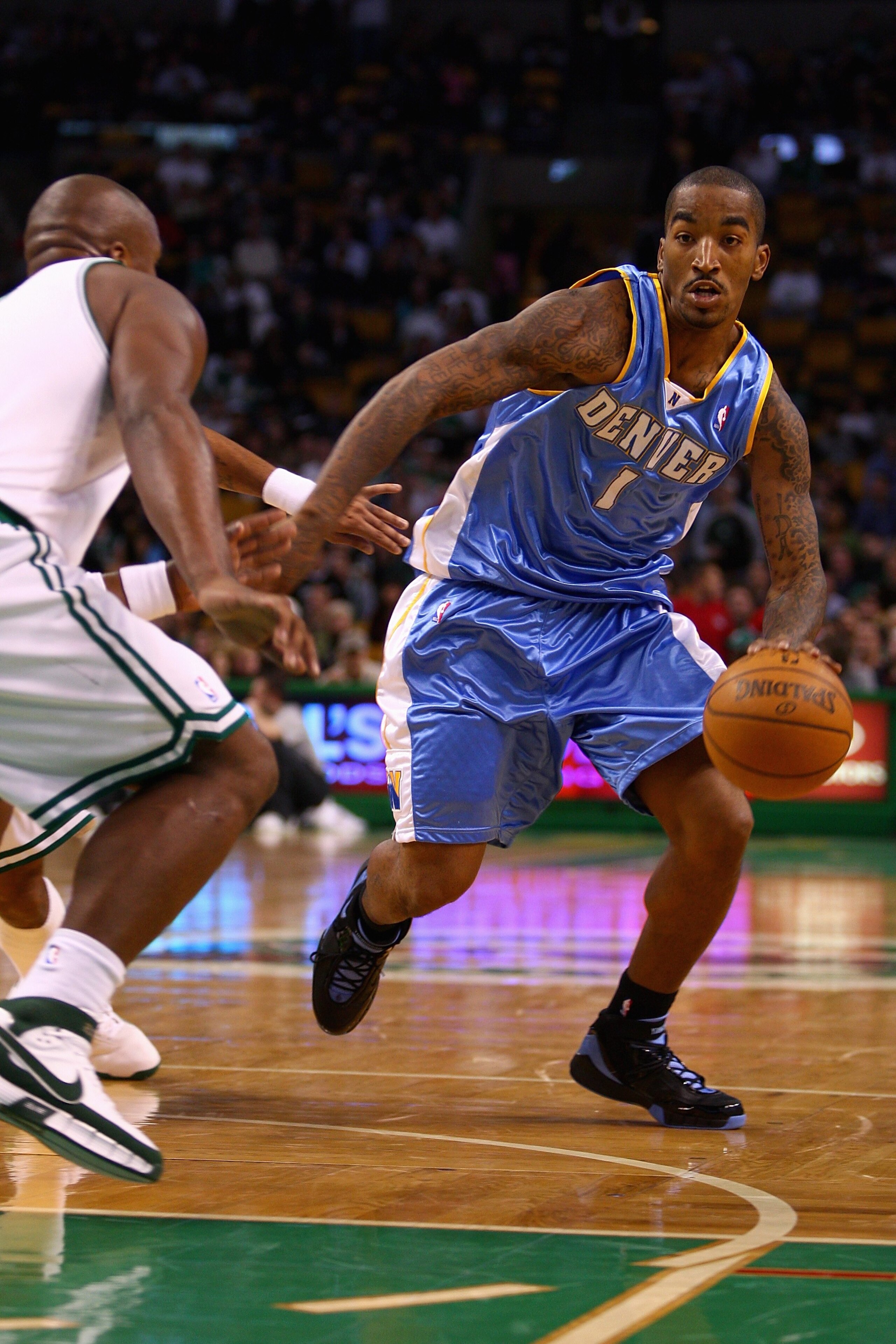 BOSTON - NOVEMBER 7: J.R. Smith #1 of the Denver Nuggets goes up against Glen Davis #11 of the Boston Celtics during the game on November 7, 2007 at the TD Banknorth Garden in Boston, Massachusetts.  The Celtics won 119-93.  NOTE TO USER: User expressly a