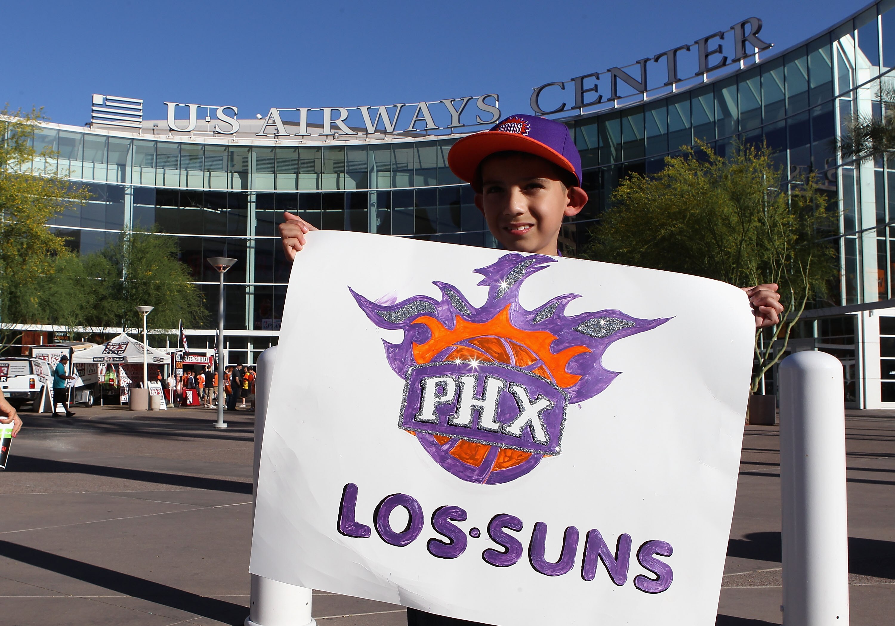 PHOENIX - MAY 05:  Phoenix Suns fan Isiah Quinonz poses with a 'Los Suns' sign before Game Two of the Western Conference Semifinals of the 2010 NBA Playoffs against the San Antonio Spurs at US Airways Center on May 5, 2010 in Phoenix, Arizona. The team is