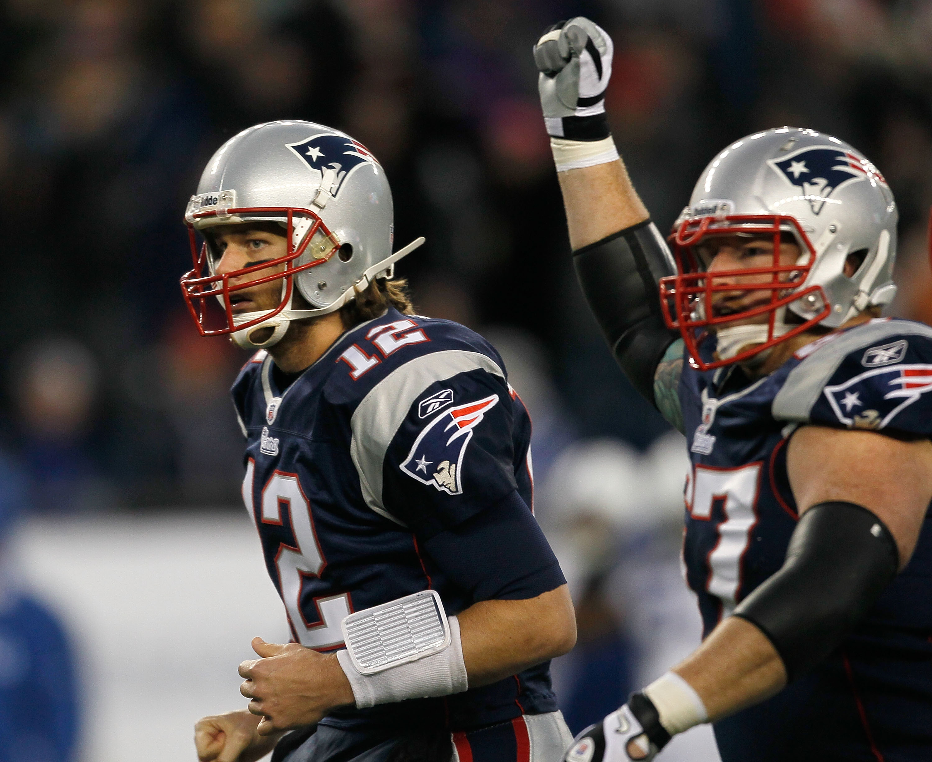 FOXBORO, MA - NOVEMBER 21: Tom Brady #12 of the New England Patriots reacts with teammate Dan Koppen #67 of the New England Patriots after a touchdown in the first half at Gillette Stadium on November 21, 2010 in Foxboro, Massachusetts. (Photo by Jim Roga