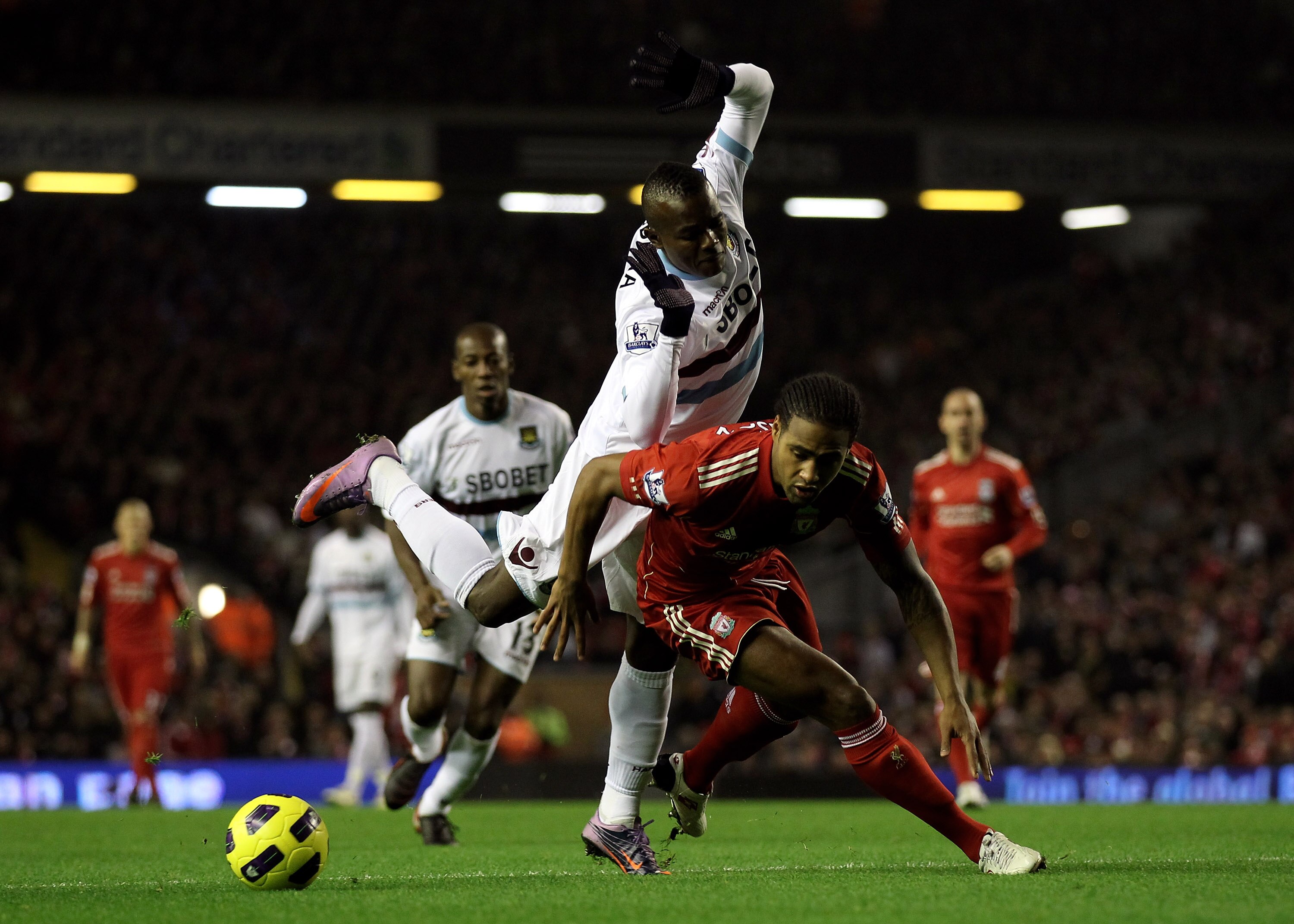 LIVERPOOL, ENGLAND - NOVEMBER 20:   Victor Obinna of West Ham United tangles with Glen Johnson of Liverpool during the Barclays Premier League match between Liverpool and West Ham United at Anfield on November 20, 2010 in Liverpool, England. (Photo by Ale