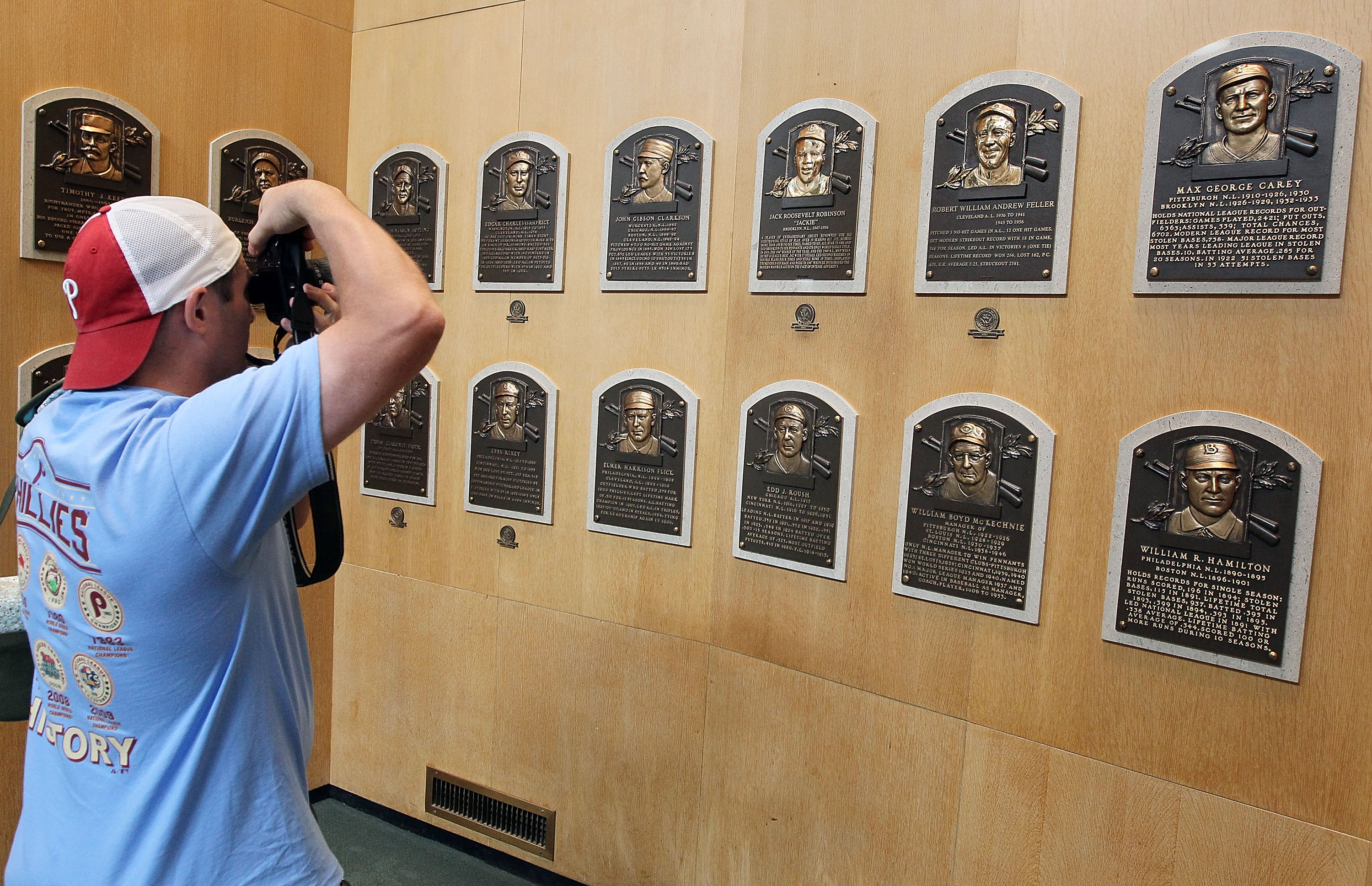 COOPERSTOWN, NY - JULY 24:  A patron of the Baseball Hall of Fame and Museum takes a photograph of the plaques of inducted members during induction weekend on July 24, 2010 in Cooperstown, New York.  (Photo by Jim McIsaac/Getty Images)