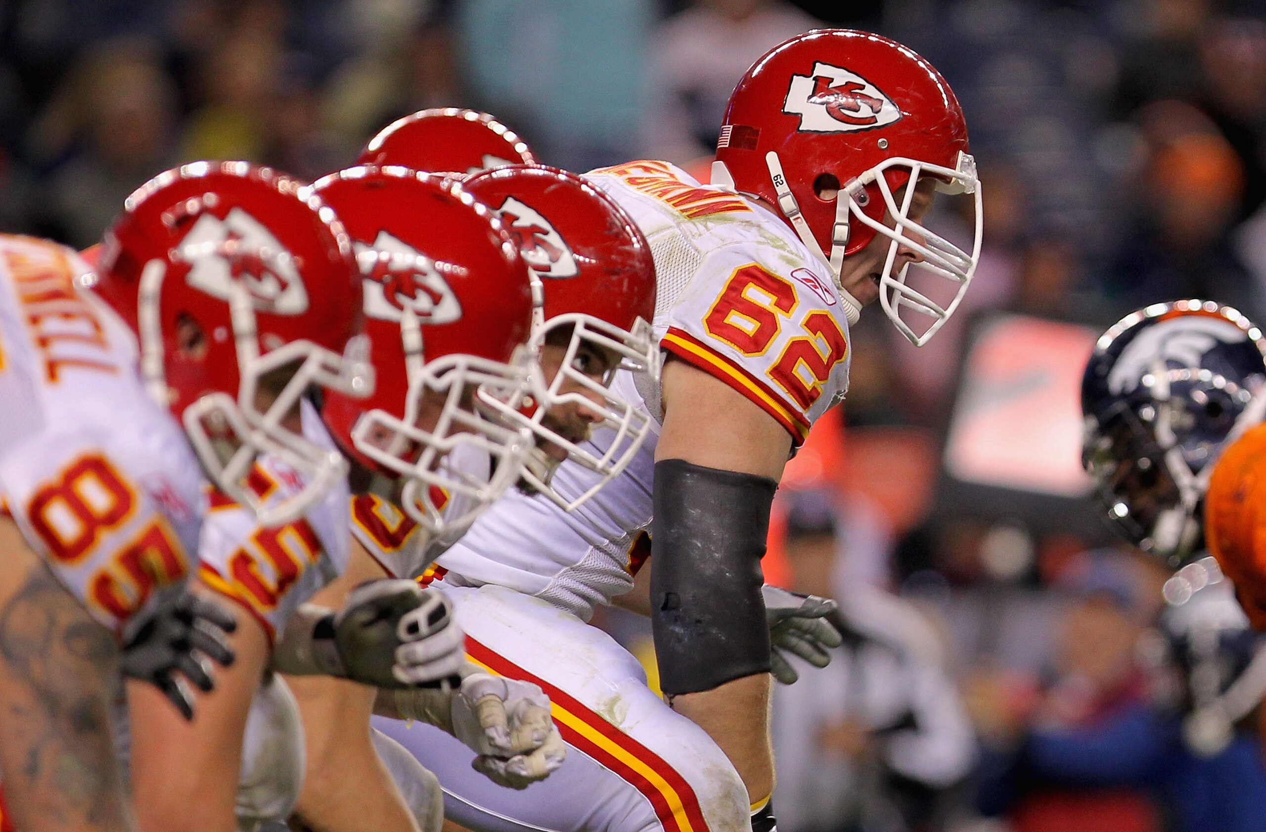 DENVER - NOVEMBER 14: Center Casey Wiegman #62 of the Kansas City Chiefs snaps the ball as the Chiefs offensive line takes on the defensive line of the Denver Bronco at INVESCO Field at Mile High on November 14, 2010 in Denver, Colorado. The Broncos defe DENVER - NOVEMBER 14: Center Casey Wiegman #62 of the Kansas City Chiefs snaps the ball as the Chiefs offensive line takes on the defensive line of the Denver Bronco at INVESCO Field at Mile High on November 14, 2010 in Denver, Colorado. The Broncos defe