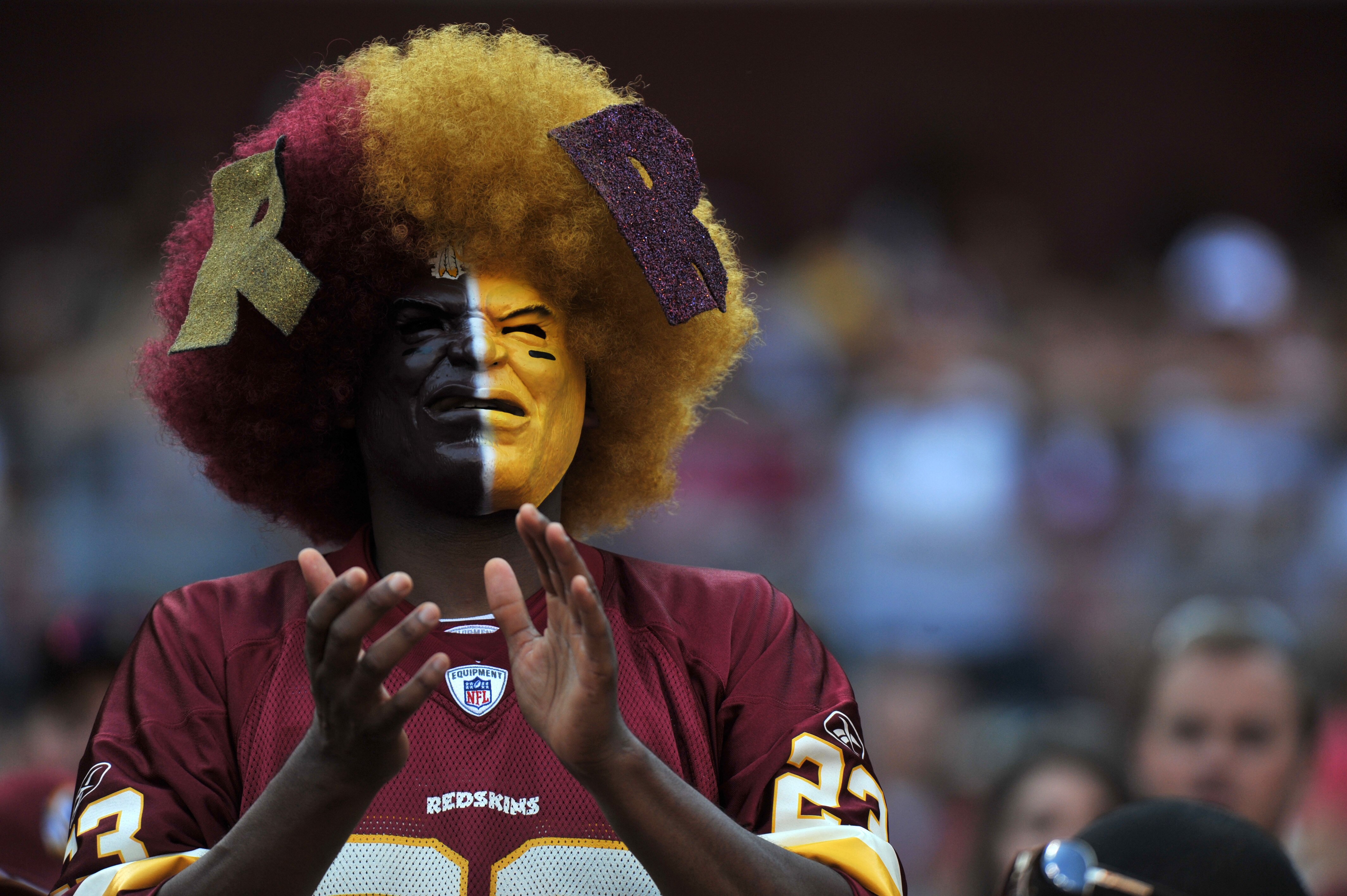 LANDOVER - SEPTEMBER 19:  A fan of the Washington Redskins cheers against the Houston Texans at FedExField on September 19, 2010 in Landover, Maryland. The Texans defeated the Redskins in overtime 30-27. (Photo by Larry French/Getty Images)