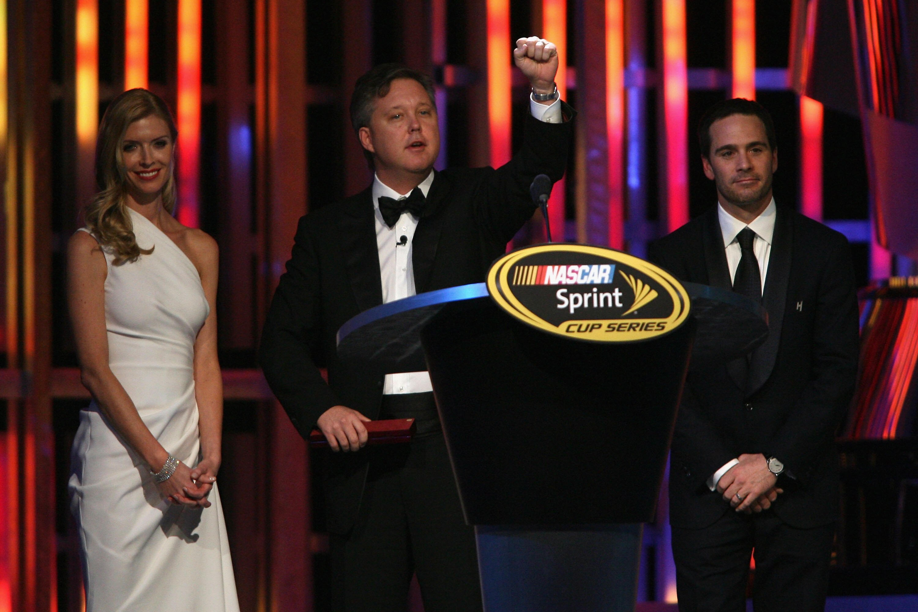 LAS VEGAS - DECEMBER 04:  NASCAR Chairman and CEO Brian France (C) introduces Four time NASCAR Sprint Cup Series Champion Jimmie Johnson (R) and his wife Chandra Johnson (L) during the 2009 NASCAR Sprint Cup Series awards banquet during the final day of t