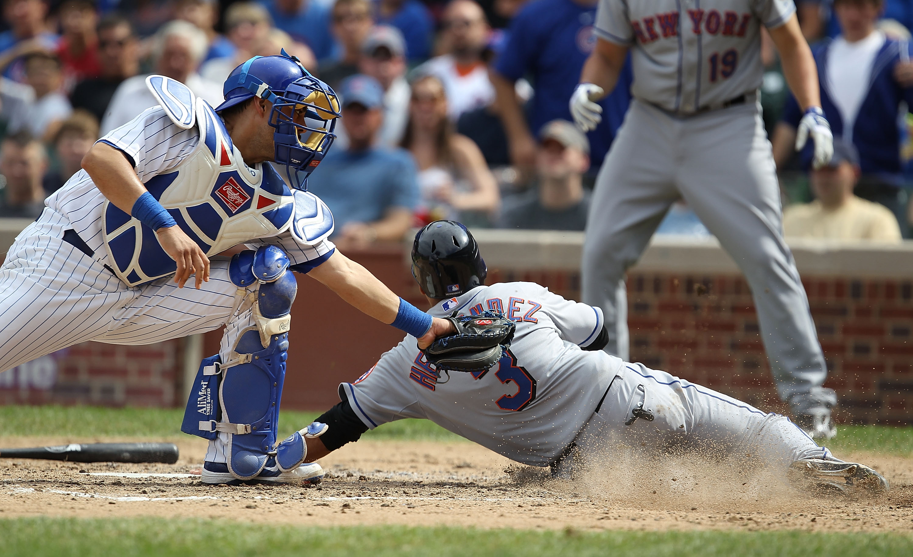 CHICAGO - SEPTEMBER 05: Luis Hernandez #3 of the New York Mets slides into home to score a run past the tag attempt of Geovany Soto #18 of the Chicago Cubs in the 5th inning at Wrigley Field on September 5, 2010 in Chicago, Illinois. (Photo by Jonathan Da