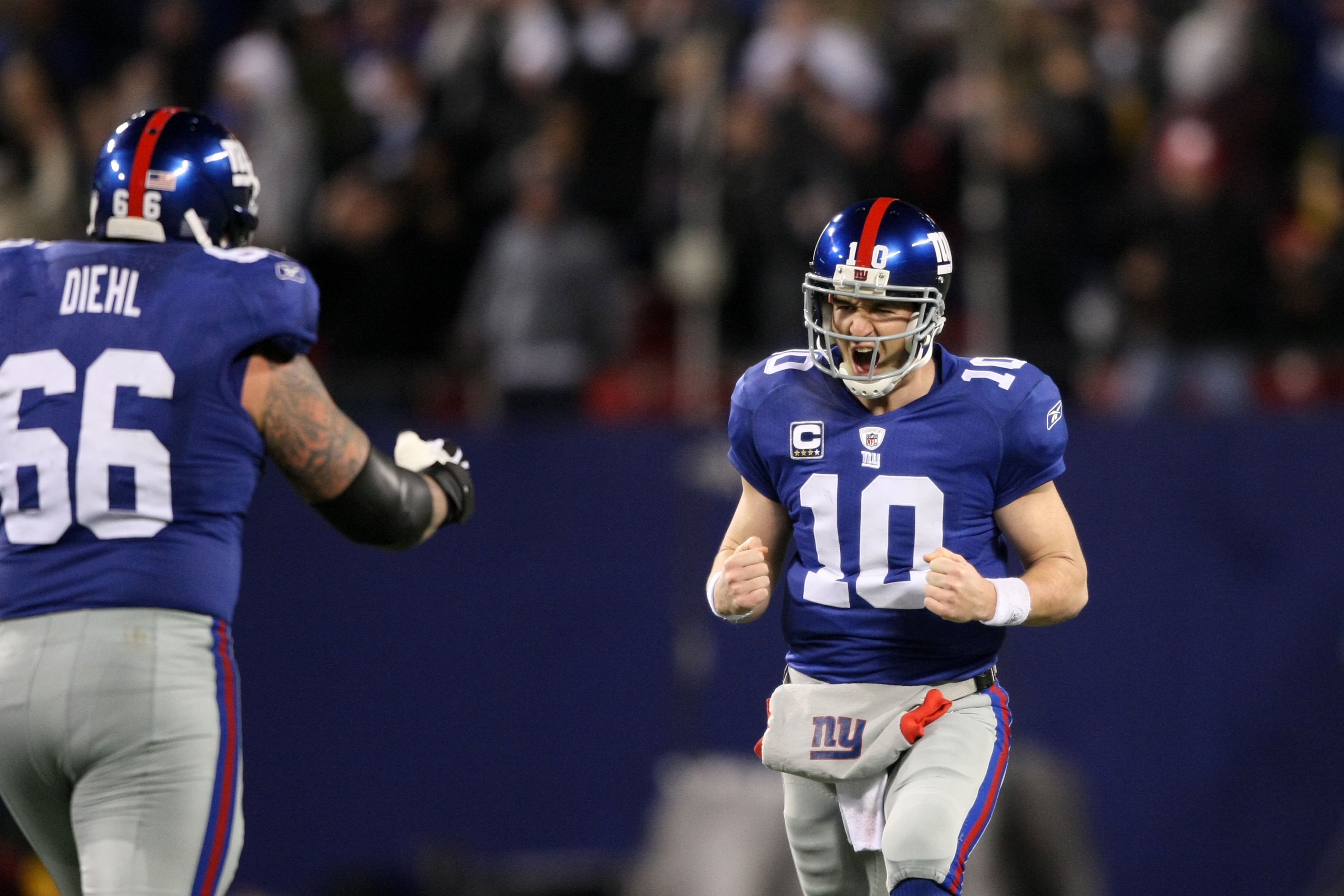 EAST RUTHERFORD, NJ - DECEMBER 13:  Eli Manning #10 of the New York Giants (R) reacts with teammate David Diehl during the game against the Philadelphia Eagles of the New York Giants at Giants Stadium on December 13, 2009 in East Rutherford, New Jersey.  