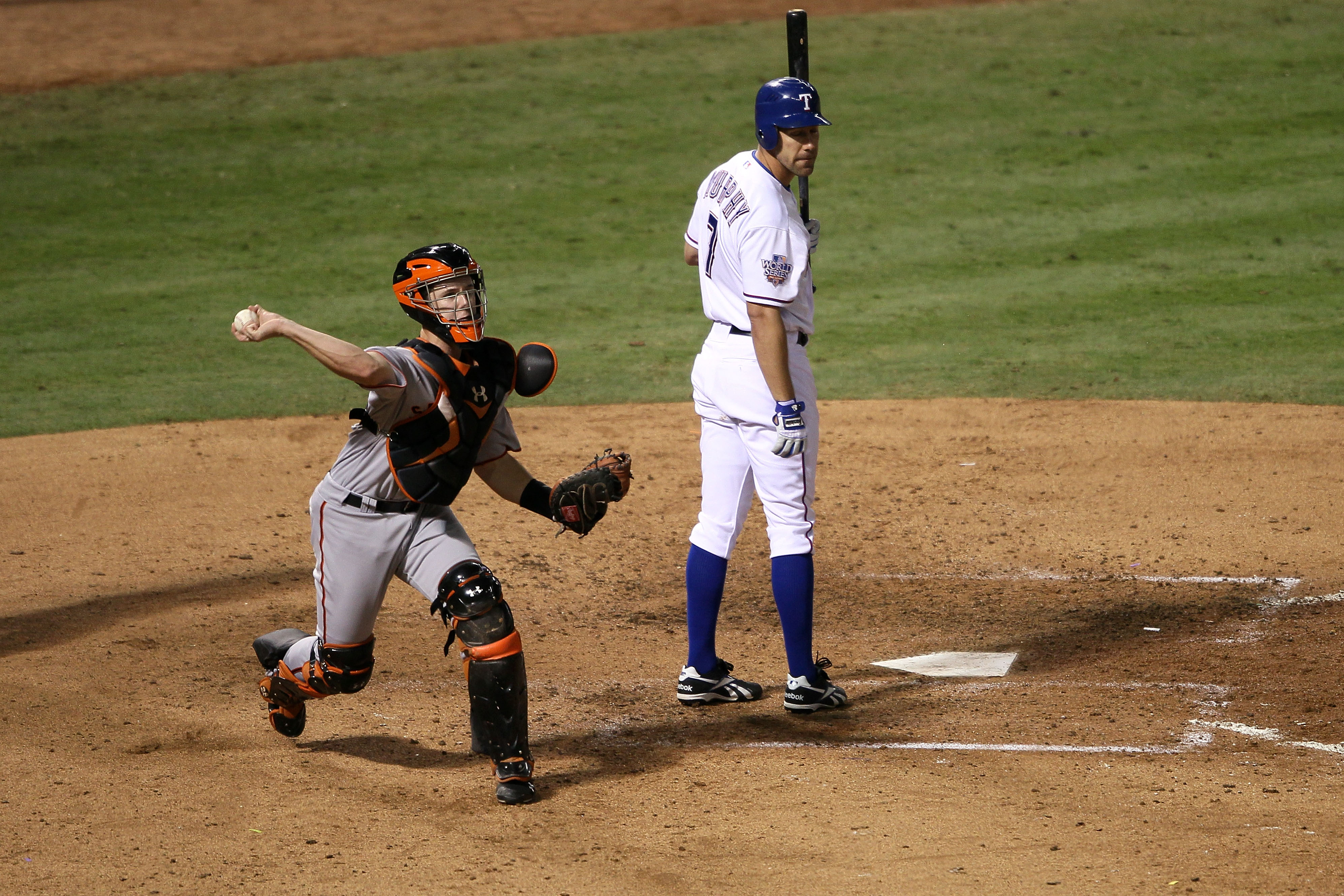 ARLINGTON, TX - NOVEMBER 01:  Catcher Buster Posey #28 of the San Francisco Giants throws the ball to first base on a failed pick off attempt behind batter David Murphy #7 of the Texas Rangers in Game Five of the 2010 MLB World Series at Rangers Ballpark