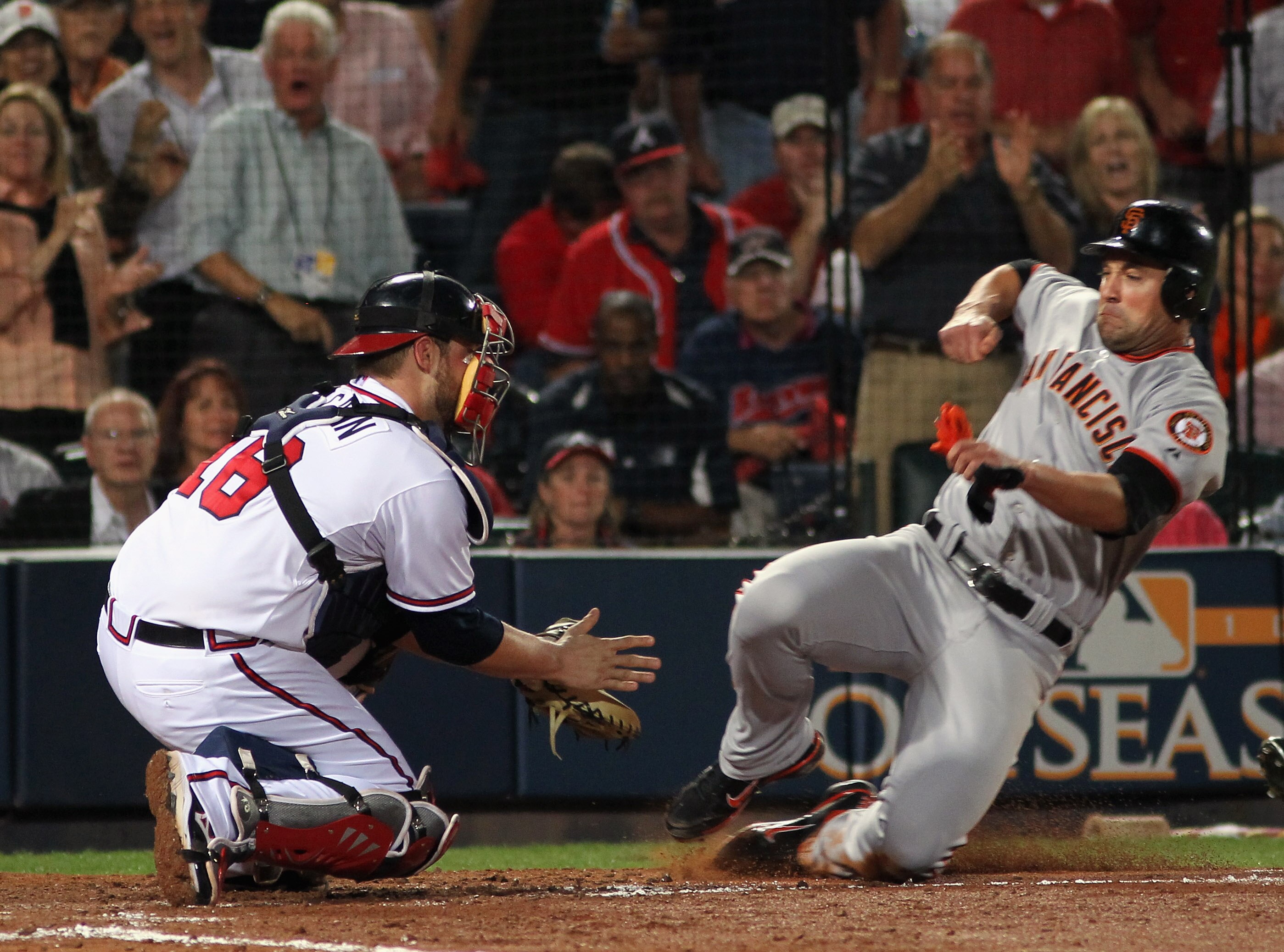 ATLANTA - OCTOBER 11:  Pat Burrell #9 of the San Francisco Giants is tagged out at home plate while trying to score by Brian McCann #16 of the Atlanta Braves during the 7th inning of Game Four of the NLDS of the 2010 MLB Playoffs on October 11, 2010  at T