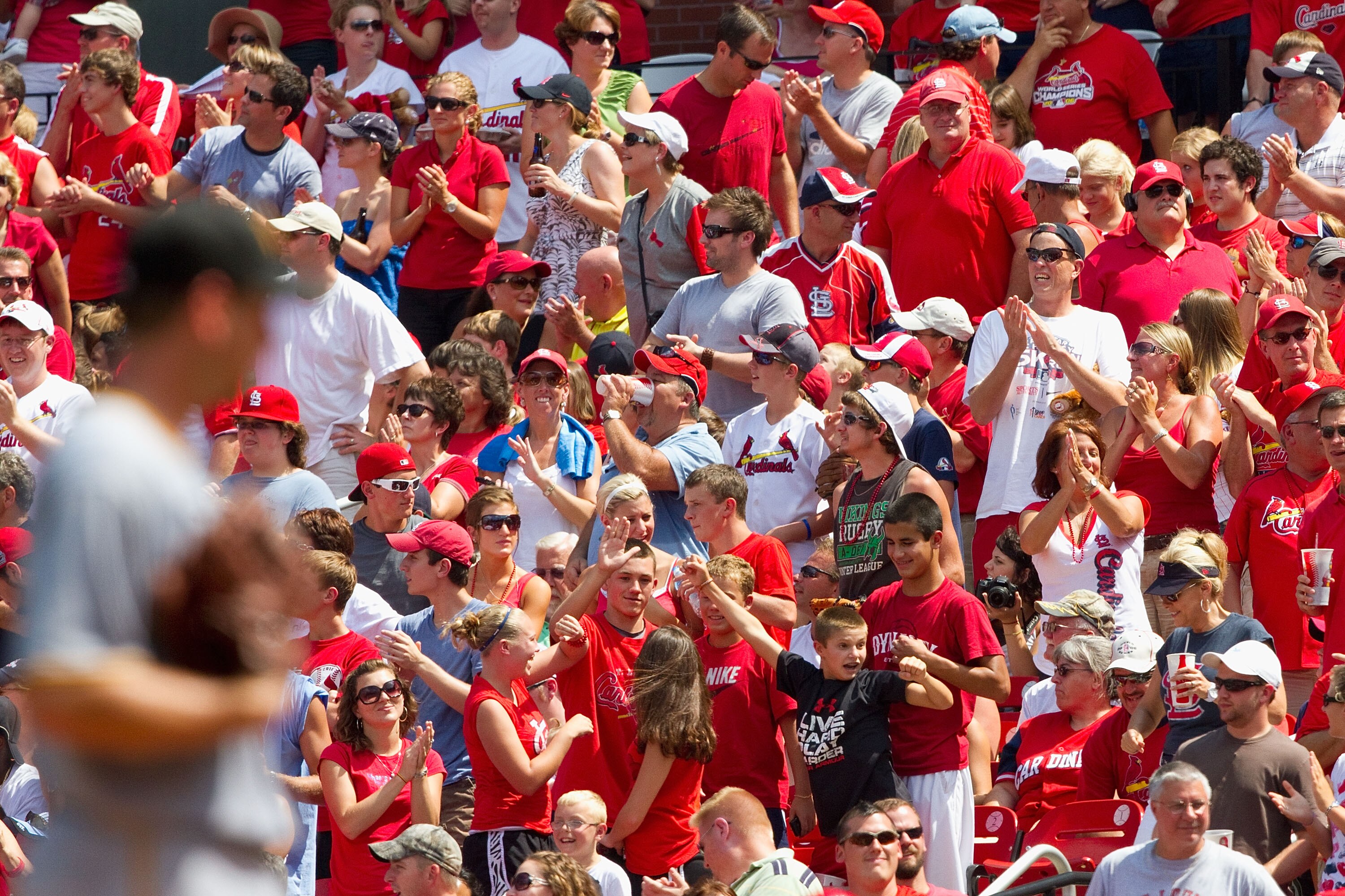 ST. LOUIS - AUGUST 1: St. Louis Cardinals fans react to a home run against the Pittsburgh Pirates at Busch Stadium on August 1, 2010 in St. Louis, Missouri.  The Cardinals beat the Pirates 9-1.  (Photo by Dilip Vishwanat/Getty Images)