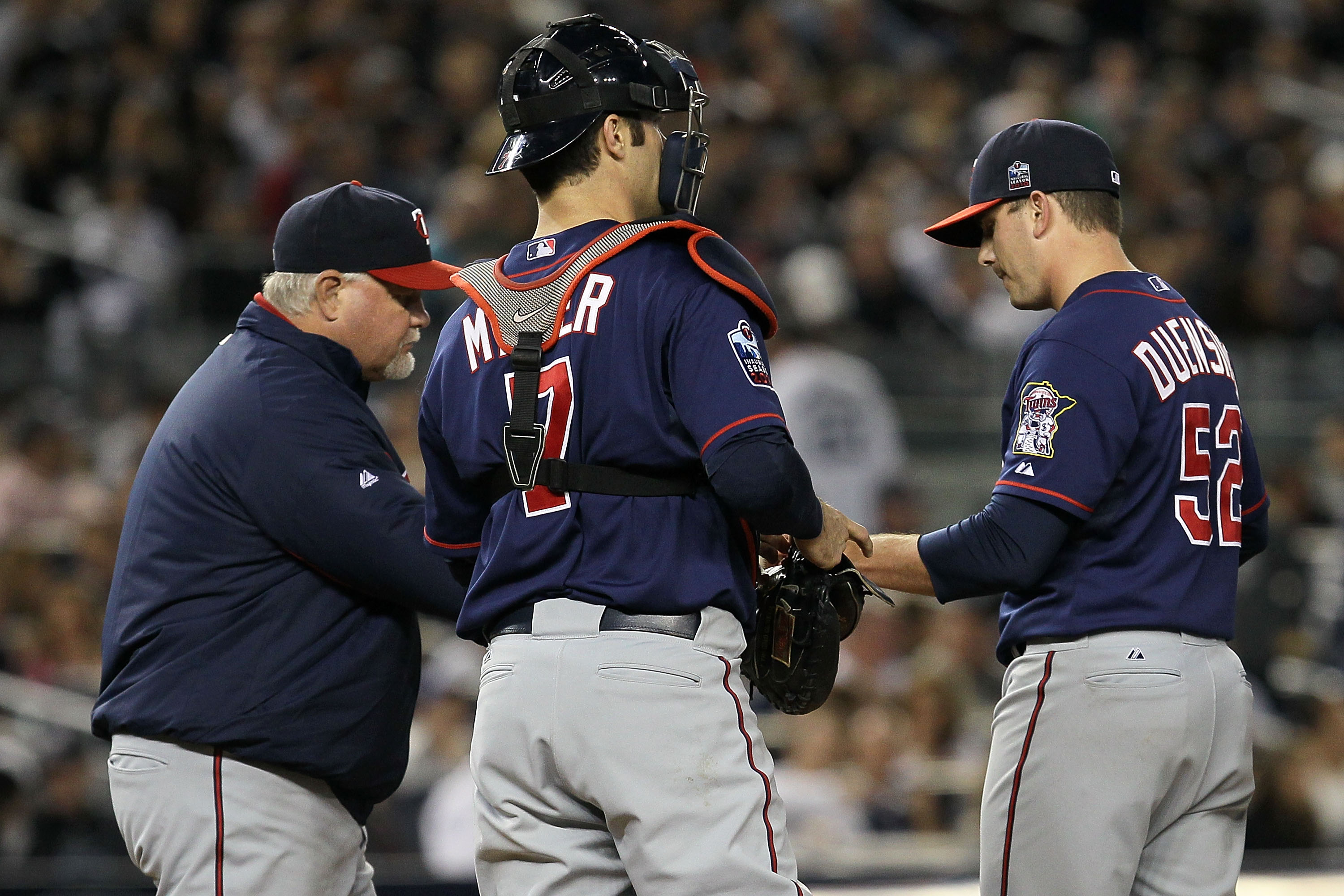NEW YORK - OCTOBER 09:  Manager Ron Gardenhire #35 (L) takes starting pitcher Brian Duensing #52 of the Minnesota Twins out of the game in the bottom of the fourth inning against the New York Yankees during Game Three of the ALDS part of the 2010 MLB Play