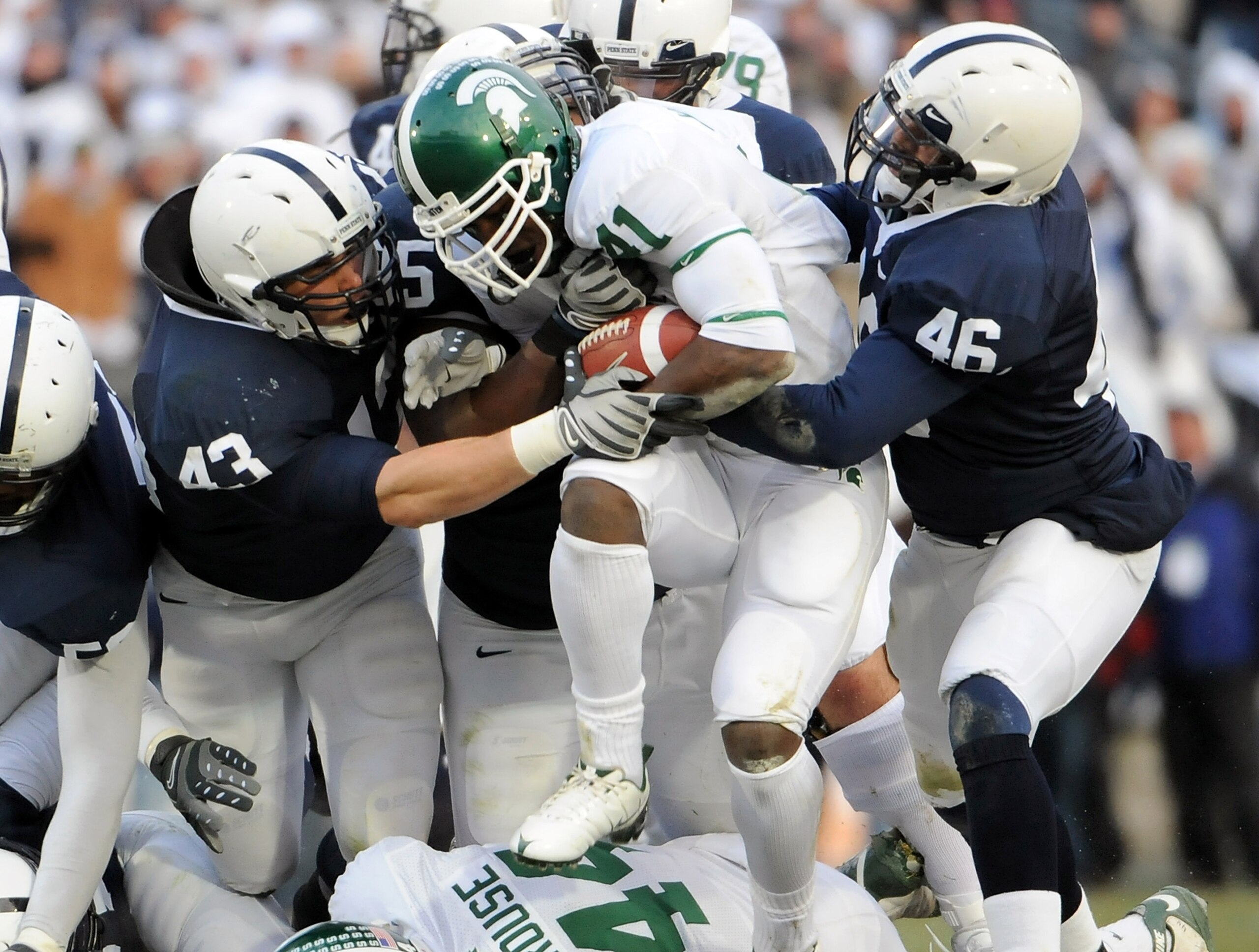 STATE COLLEGE, PA - NOVEMBER 22:  Glenn Winston #41 of the Michigan State Spartans is stopped for a loss by Josh Hull #43 and Tyrell Sales #46 of the Penn State Nittany Lions on November 22, 2008 at Beaver Stadium in State College, Pennsylvania.  (Photo b