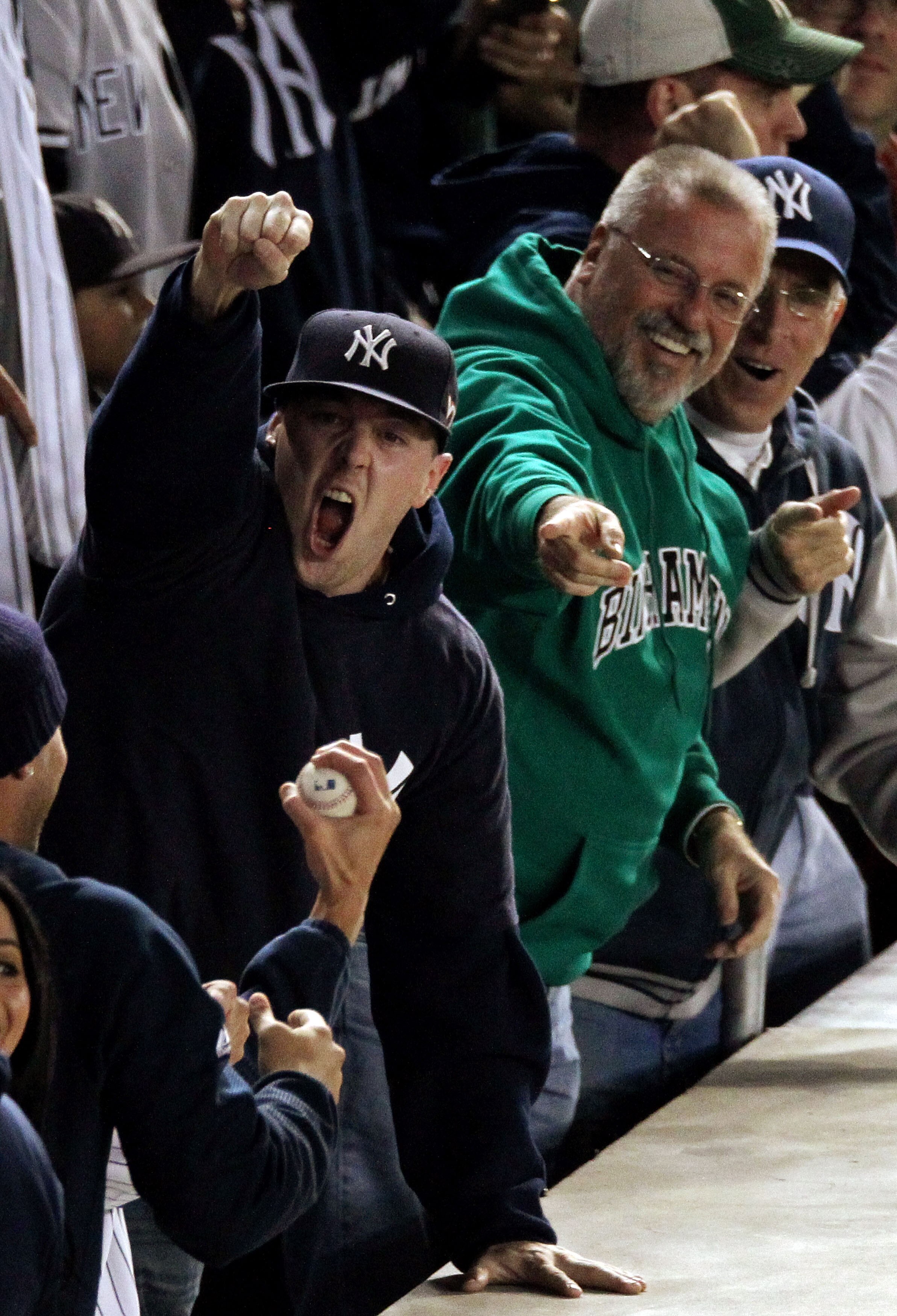 NEW YORK - OCTOBER 19:  A fan of the New York Yankees reacts after catching a home run ball hit by Robinson Cano #24 of the Yankees in the bottom of the seocnd inning against the Texas Rangers in Game Four of the ALCS during the 2010 MLB Playoffs at Yanke