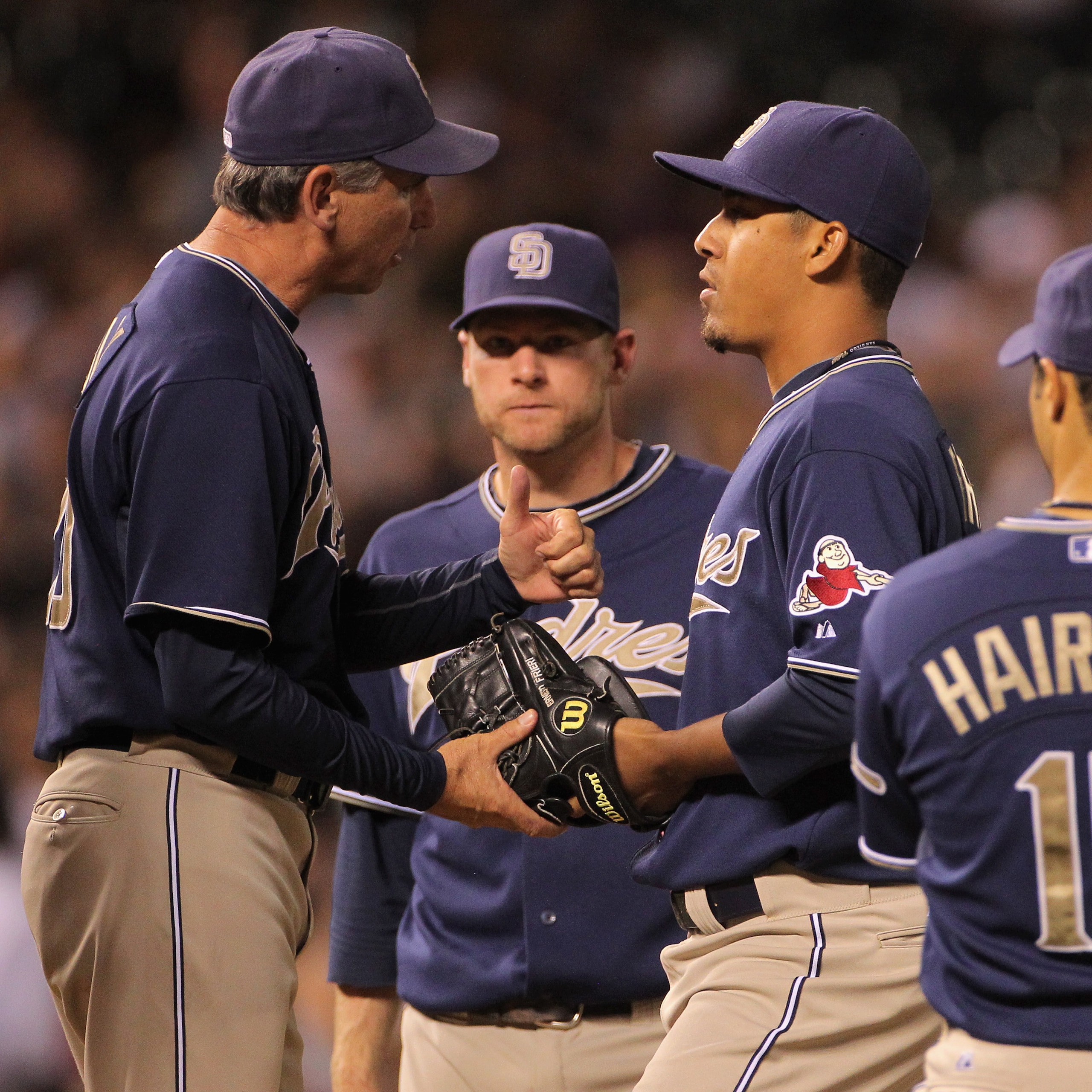 DENVER - SEPTEMBER 13:  Manager Bud Black #20 gives the ball to relief pitcher Ernesto Frieri #39 of the San Diego Padres as he enters the game in the fifth inning against the Colorado Rockies at Coors Field on September 13, 2010 in Denver, Colorado. Frie