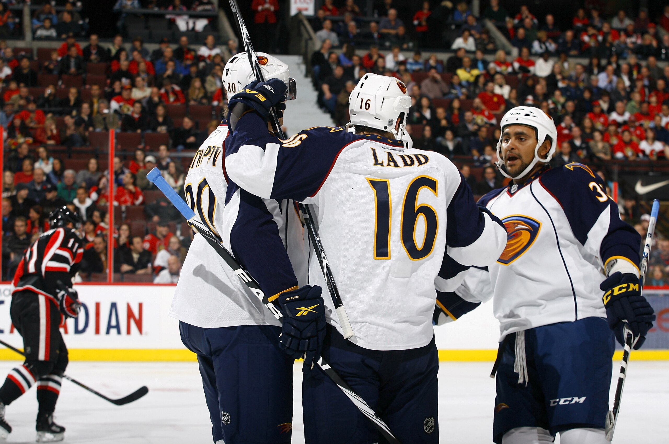 OTTAWA - NOVEMBER 09:  Andrew Ladd #16 of the Atlanta Thrashers celebrates his goal with teammates Nik Antropov #80 and Dustin Byfuglien #33 while Daniel Alfredsson #11 of the Ottawa Senators skates away dejectedly during a game at Scotiabank Place on Nov