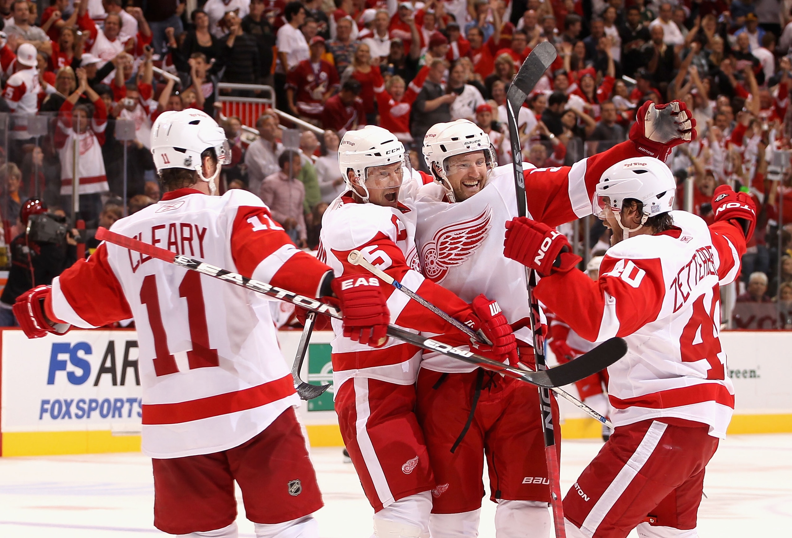 GLENDALE, AZ - OCTOBER 16:  Niklas Kronwall #55 of the Detroit Red Wings celebrates with teammates (L-R) Daniel Cleary #11, Nicklas Lidstrom #5 and Henrik Zetterberg #40 after Kronwall scored the game winning power play goal in overtime against the Phoeni