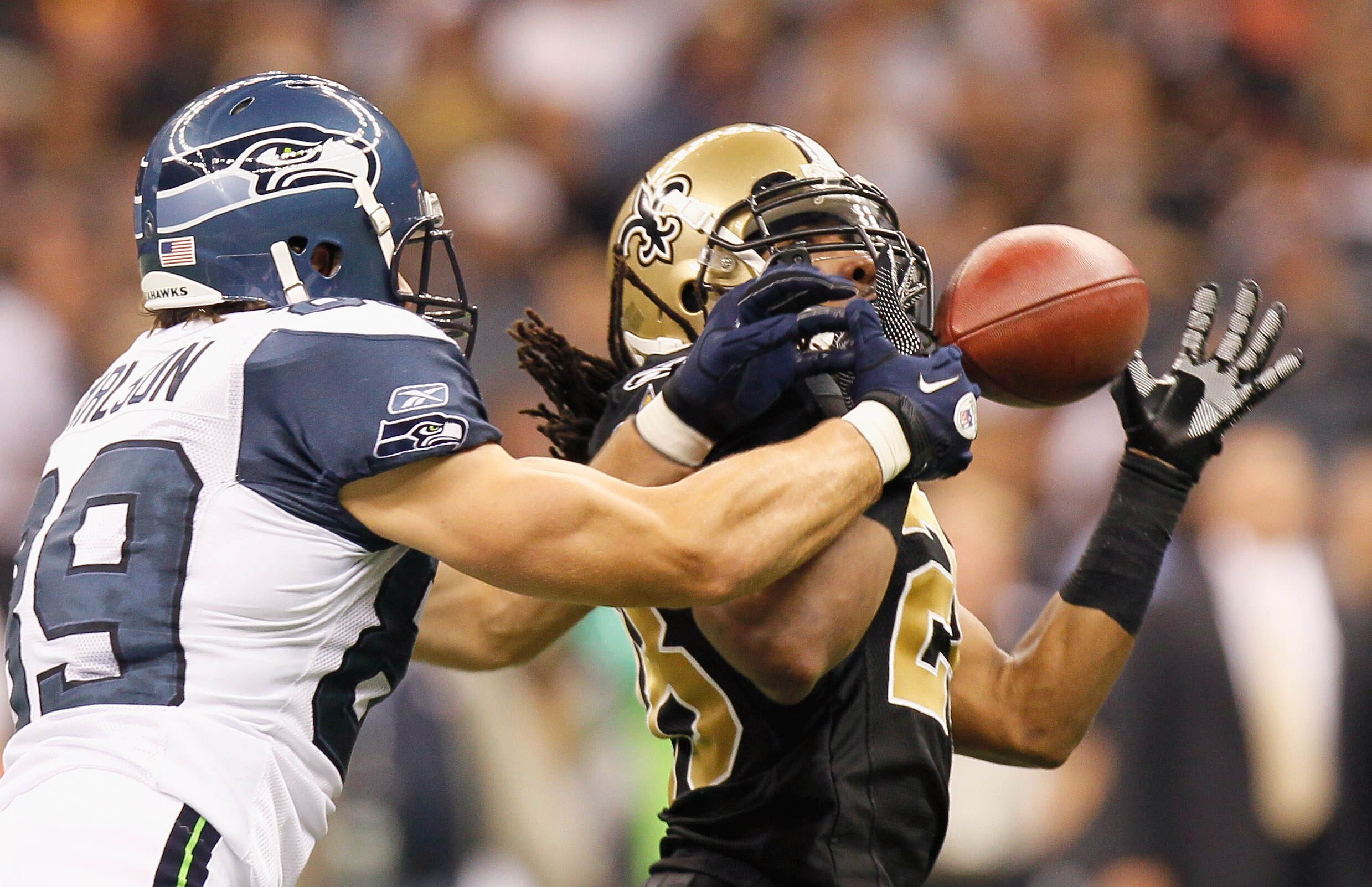 NEW ORLEANS - NOVEMBER 21:  Usama Young #28 of the New Orleans Saints nearly picks off a pass intended for John Carlson #89 of the Seattle Seahawks at Louisiana Superdome on November 21, 2010 in New Orleans, Louisiana.  (Photo by Kevin C. Cox/Getty Images