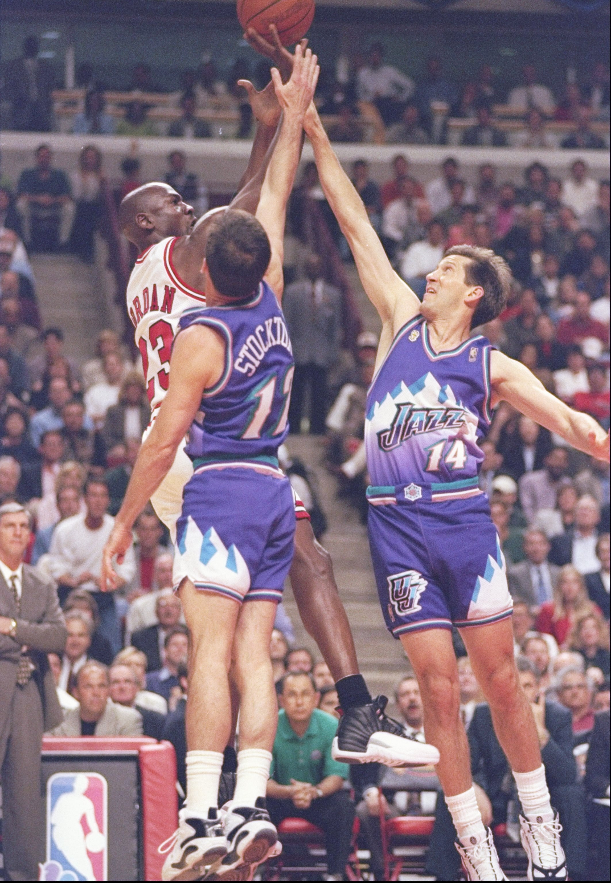 4 Jun 1997: Guard Michael Jordan of the Chicago Bulls shoots the ball over guards Jeff Hornacek and John Stockton of the Utah Jazz during a playoff game at the United Center in Chicago, Illinois. The Bulls won the game 97-85.