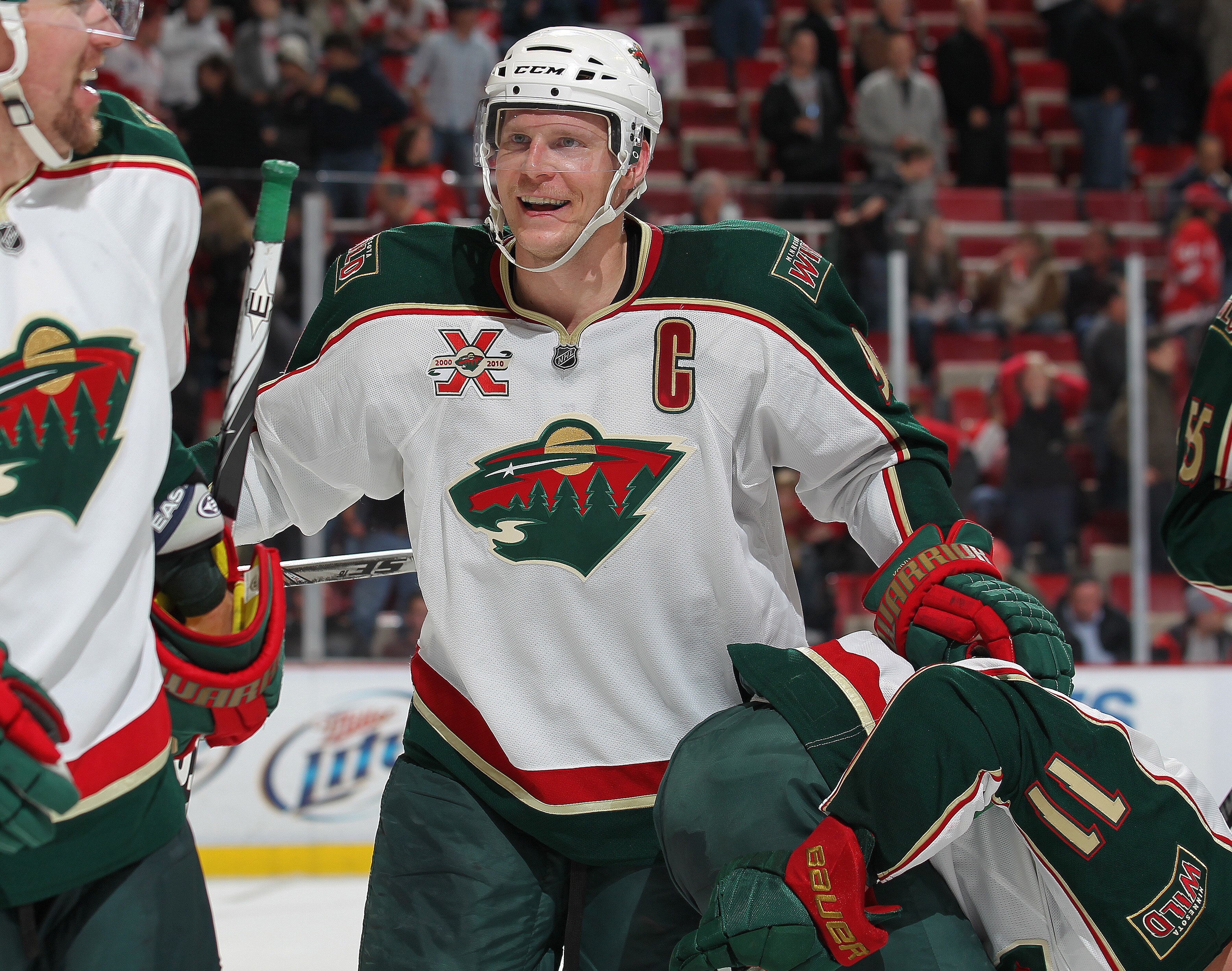 DETROIT, MI - NOVEMBER 19:  Mikko Koivu #9 of the Minnesota Wild celebrates a goal by teammate John Madden #11 in overtime in a game against the Detroit Red Wings on November 19, 2010 at the Joe Louis Arena in Detroit, Michigan. The Wild defeated the Wing